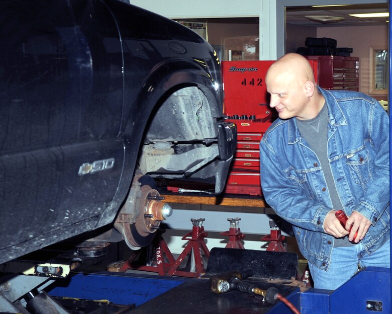 WHITEMAN AIR FORCE BASE, Mo., - Randy Moninger, 509th Operations Support Squadron air traffic controller, examines his front brake pads as technicians from the Whiteman Auto Hobby Shop perform a Missouri State Vehicle Inspection on his vehicle. The auto hobby shops offers an array of automotive services for Team Whiteman members. (U.S. Air Force photo/Airman 1st Class Torey Griffith)(Released) 