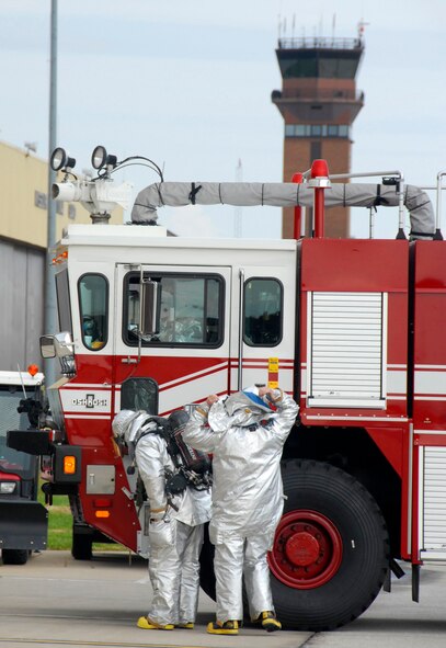 Firemen from the 442nd Fighter Wing's 442nd Civil Engineer Squadron prepare for action as they don their gear in anticipation of battling a simulated fire during the wing's October 2009 operational readiness inspection at Whiteman Air Force Base, Mo. (U.S. Air Force photo/Staff Sgt. Kent L. Kagarise)