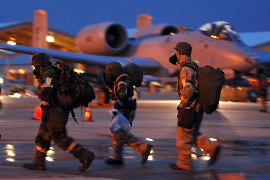 Three members of the 442nd Maintenance Group walk to the flightline at Whiteman Air Force Base, Mo., Oct. 26 to participate in the 442nd Fighter Wing's operational readiness inspection.  An inspector general team from Headquarters Air Combat Command arrived at Whiteman Oct. 23 and are expected to deliver a preliminary report Oct. 29.  The 442nd Fighter Wing is an Air Force Reserve Command unit based at Whiteman.  The wing operates, maintains and supports a squadron of A-10 Thunderbolt II ground-attack aircraft.  (U.S. Air Force photo/Senior Airman Kenny Holston)