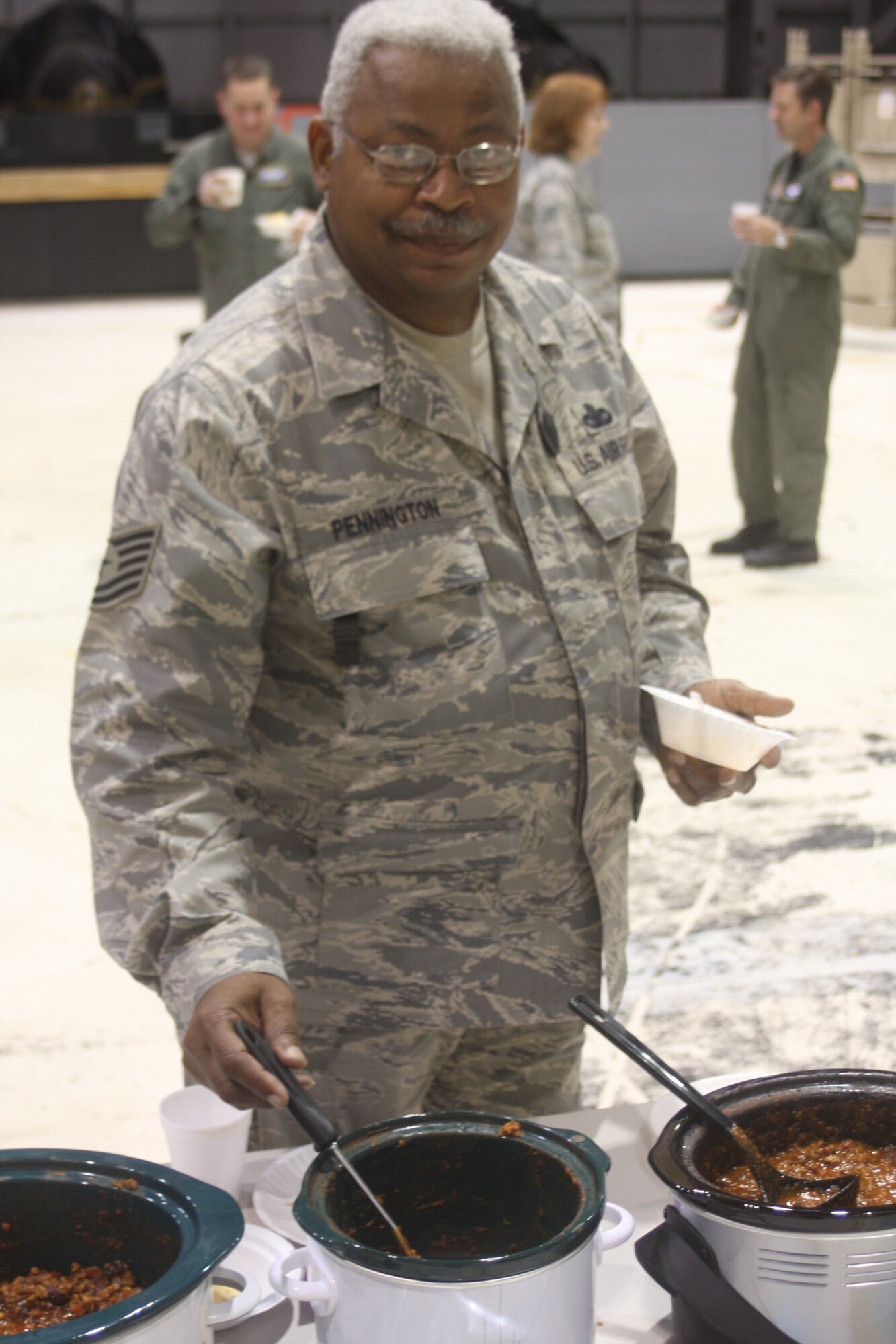 WRIGHT-PATTERSON AIR FORCE BASE, Ohio – Tech. Sgt. Michael Pennington, 445th Security Forces Squadron, stirs his chili, titled, “acres chili,” which took first place in the 445th Airlift Wing’s annual Combined Federal Campaign chili cook-off Oct. 27.  The wing made a profit of $417.86 for the CFC. (U. S. Air Force photo/Senior Airman Mikhail Berlin)