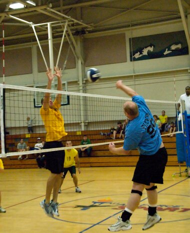 Dustin Brisson puts a hard spike on the ball as Brian Titze attempts to block in the second match of the Charleston AFB intramural volleyball championship game at the Fitness and Sports Center here Oct. 22. The 437th Operations Group/Operations Support Squadron Flyers won the first match of the set, followed by two consecutive match wins by the 437th Aerial Port Squadron. Brisson is a Web operations technician with the 437 OG and Titze is a passenger service agent with the 437 APS. (U.S. Air Force photo/Staff Sgt. Daniel Bowles)