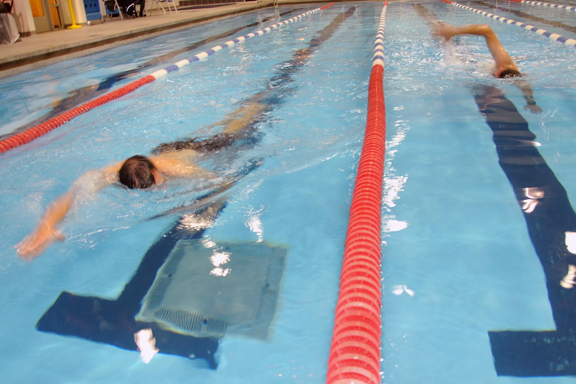 OFFUTT AIR FORCE BASE, Neb. - Swimmers slug it out in the Offutt Field House swimming pool here Oct. 24 during the Offutt Triathlon. During the event, competitors swam 400 yards, biked 12 miles and ran 4 miles. U.S. Air Force photo by Jeff W. Gates.
