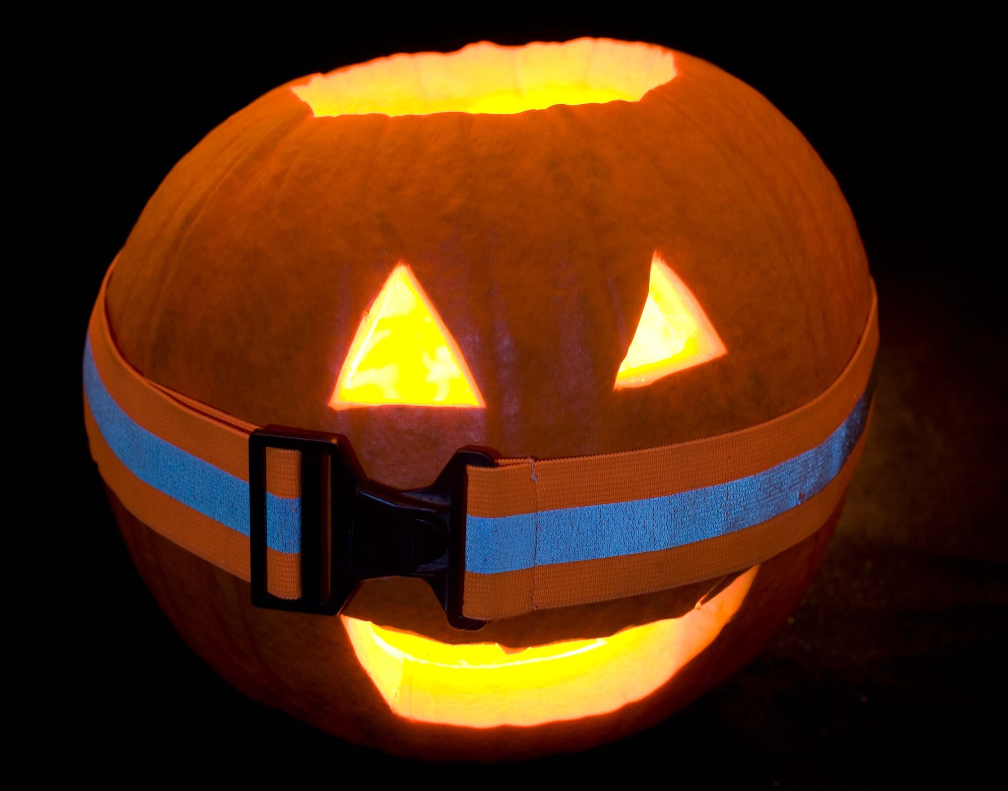 Freddy, the 1st Fighter Wing Public Affairs' jack-o'-lantern, dons a reflective belt in preparation for a safe Halloween at Langley Air Force Base, Va. (U.S. Air Force photo/Staff Sgt. Barry Loo) 
