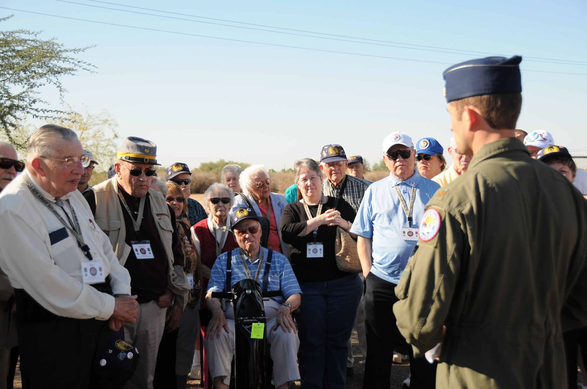 Maj. Sean Holahan, an instructor pilot with the 301st Fighter Squadron, tells about the 944th Fighter Wing mission and the capabilities of the F-16 during a tour Oct. 23. The 486th and 487th Bomb Groups conducted their annual reunion in Phoenix and visited the base as one of their events. Both bomb groups flew combat missions during World War II. (U.S. Air Force photo/Tech. Sgt. Susan Stout)