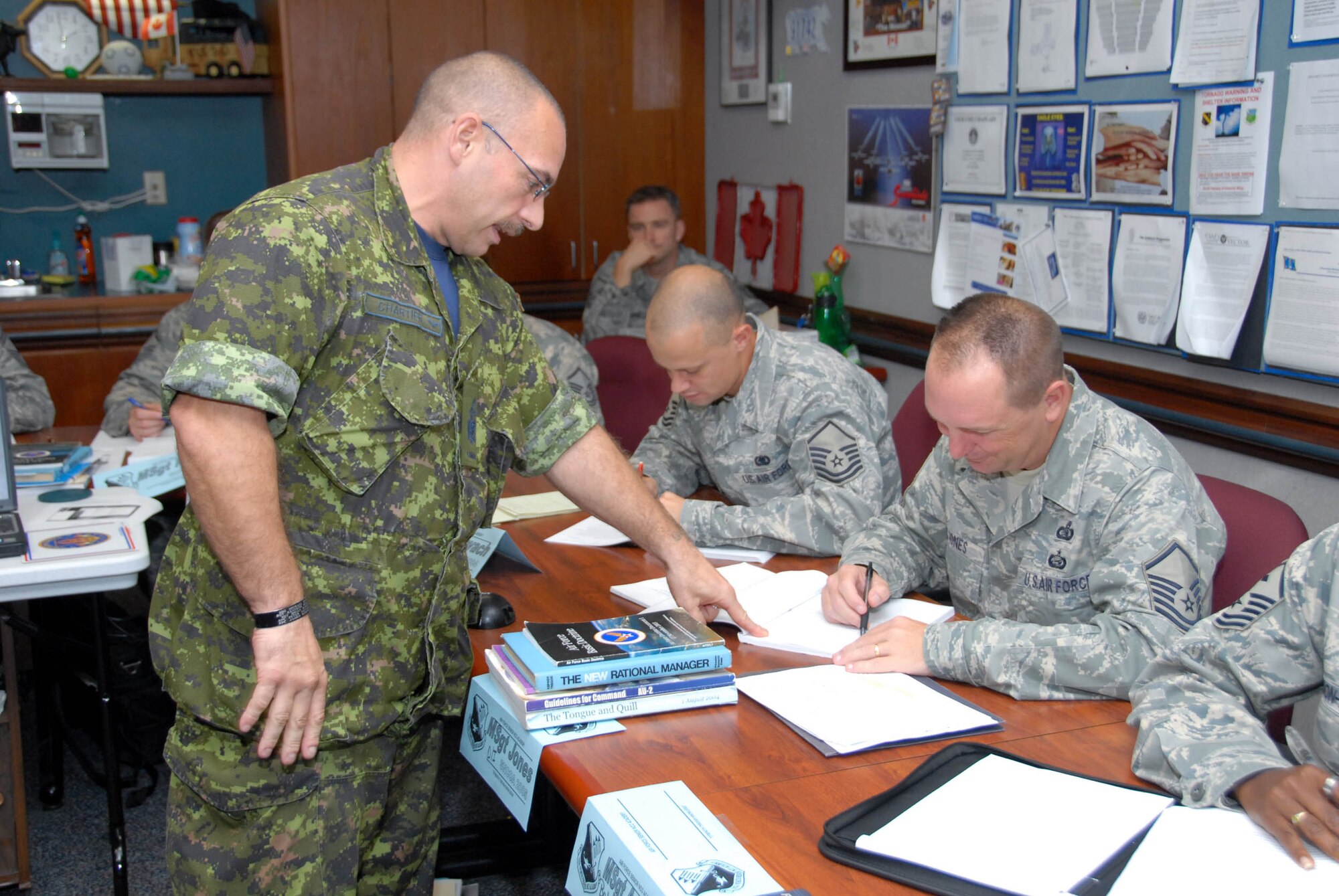 Chief Warrant Officer Gabriel Chartier, an instructor at the Air Force Senior NCO Academy, briefs a case study to his students at the academy Oct. 23. CWO Chartier is assisting the Air Force as an educational instructor. (U.S. Air Force photo/Bennett Rock)

