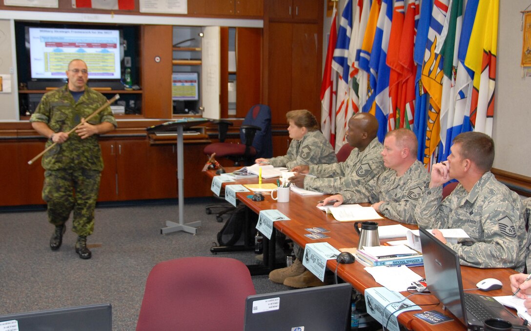 Chief Warrant Officer Gabriel Chartier, an instructor at the Air Force Senior NCO Academy, briefs a case study to his students at the academy Oct. 23. CWO Chartier is assisting the Air Force as an educational instructor. (U.S. Air Force photo/Bennett Rock)

