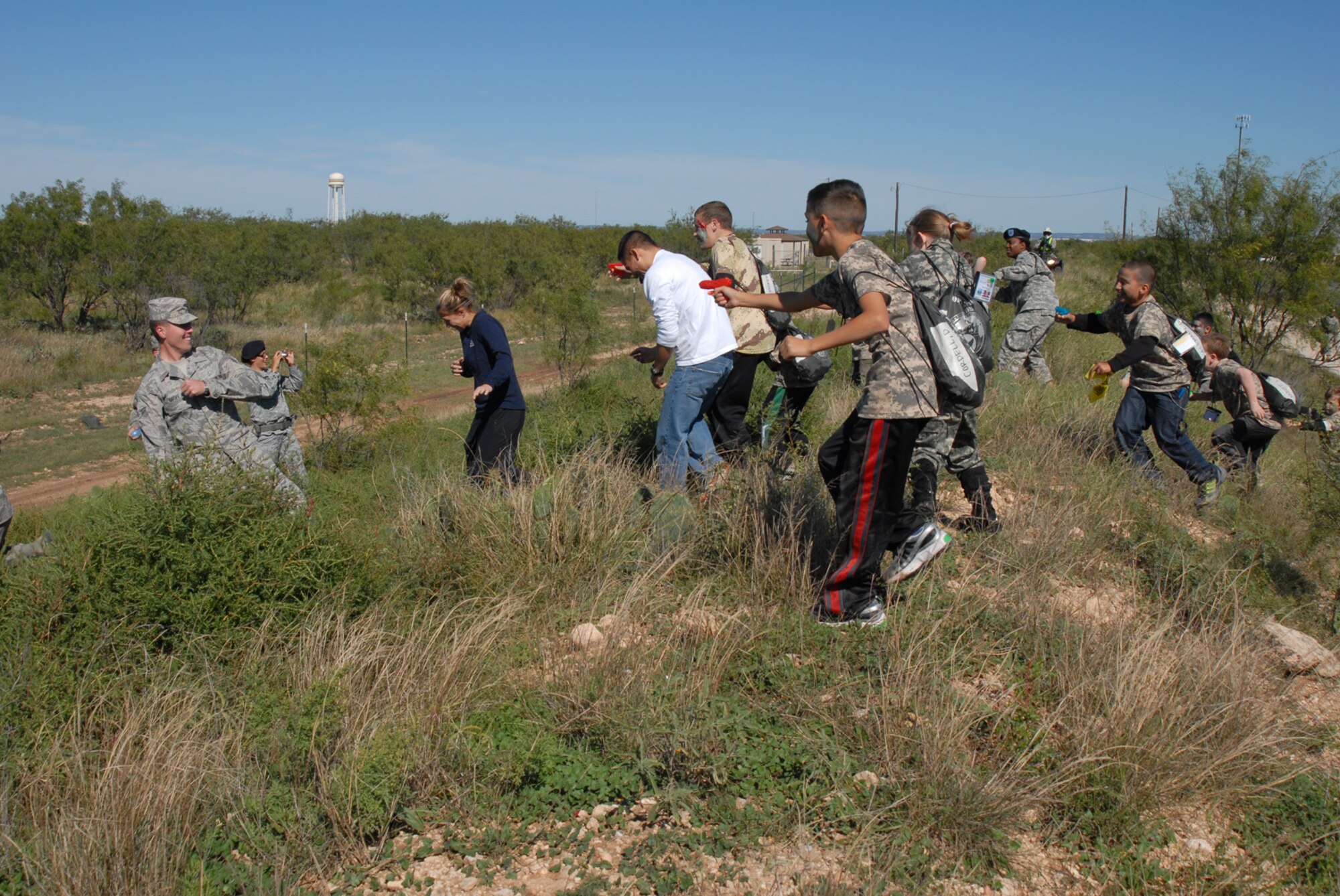 GOODFELLOW AIR FORCE BASE, Texas -- Children of military personnel attempt to "repel ambushers" on their ruck march during Operation Kids, Oct. 24, 2009. Operation Kids is a group of activities designed to increase dependents' understanding of the deployment process. (U.S. Air Force photo/Staff Sgt. Laura R. McFarlane)