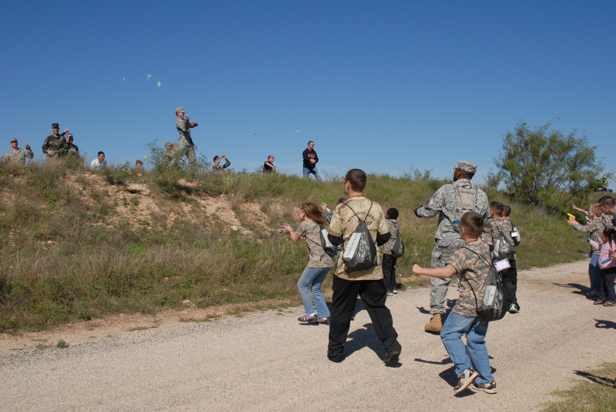 GOODFELLOW AIR FORCE BASE, Texas -- Children of military personnel "come under attack from ambushers" on their ruck march during Operation Kids, Oct. 24, 2009. Operation Kids is a group of activities designed to increase dependents' understanding of the deployment process. (U.S. Air Force photo/Staff Sgt. Laura R. McFarlane)