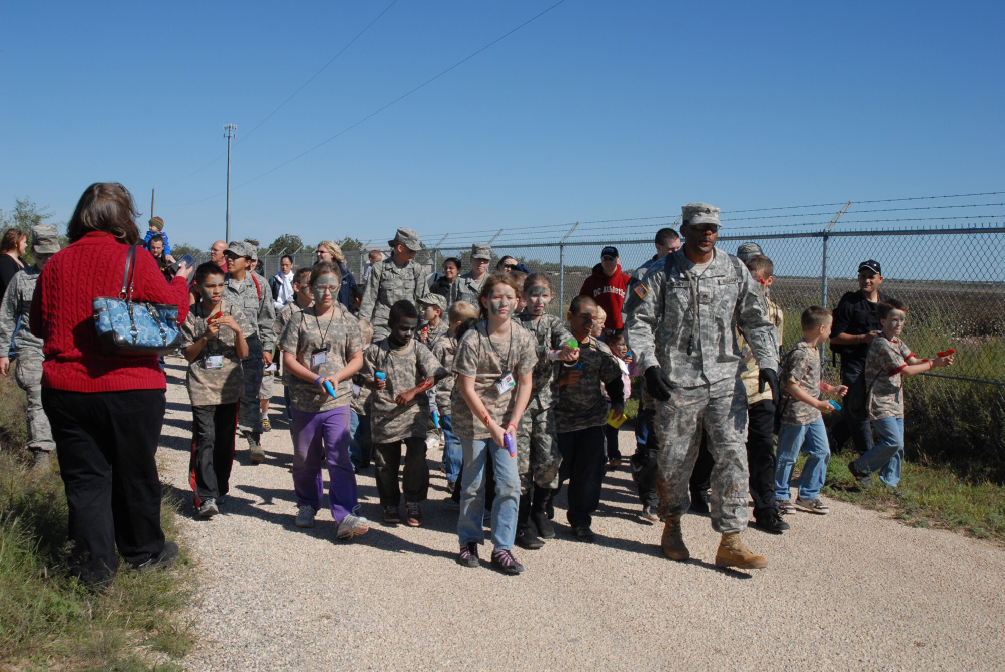 GOODFELLOW AIR FORCE BASE, Texas -- Army Staff Sgt. Karl Henry, 344th Military Intelligence Battalion, leads children of military personnel on a ruck march during Operation Kids, Oct. 24, 2009. Operation Kids is a group of activities designed to increase dependents' understanding of the deployment process. (U.S. Air Force photo/Staff Sgt. Laura R. McFarlane)

