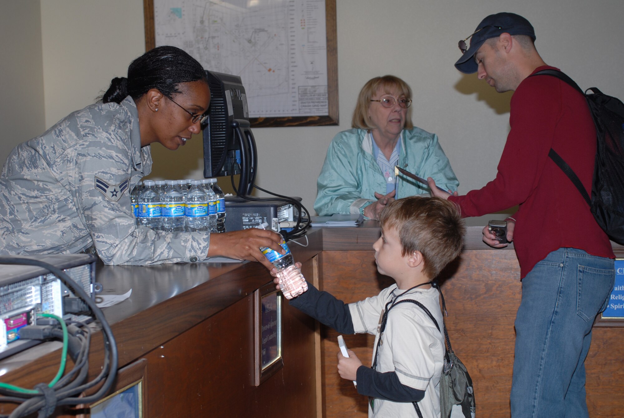 GOODFELLOW AIR FORCE BASE, Texas -- Kurt Spomer, son of Capt. Matthew Spomer, 315th Training Squadron instructor, receives his "canteen" for deployment from Airman 1st Class Adrianne Crump, 17th Force Support Squadron, during Operation Kids, Oct. 24, 2009. Operation Kids is a group of activities designed to increase dependents' understanding of the deployment process. (U.S. Air Force photo/Staff Sgt. Laura R. McFarlane)