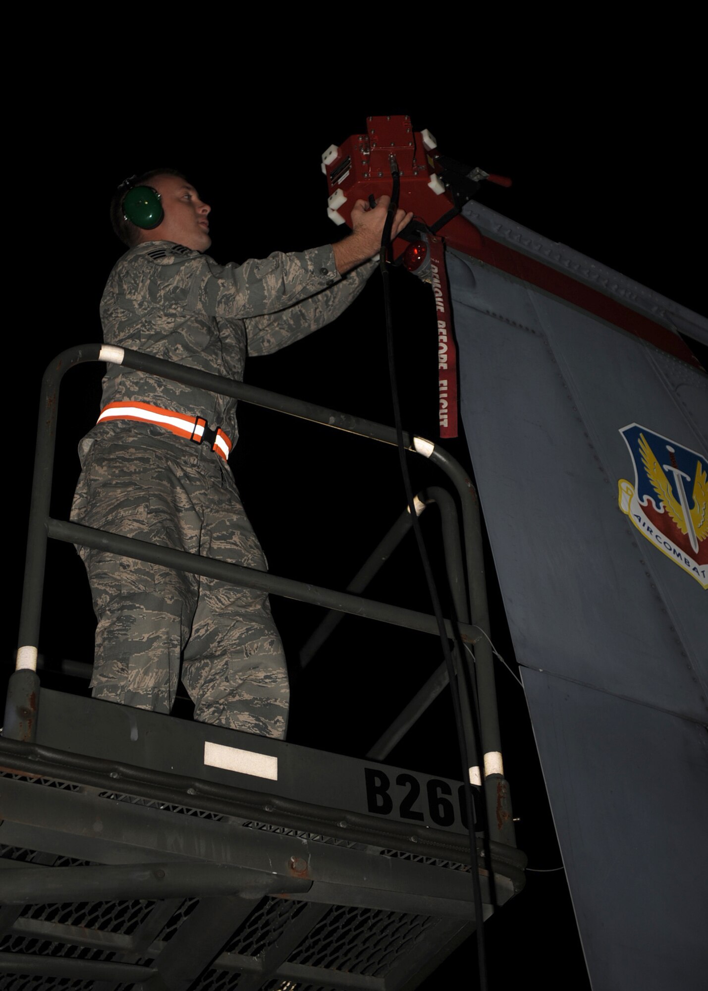 Senior Airman Timothy Puckett, Combat Shield team member from Eglin Air Force Base, Fla., removes an antenna coupler from the vertical stabilizer of an F-15E Strike Eagle on Seymour Johnson Air Force Base, N.C., Oct. 20, 2009. Combat Shield is a five day exercise that tests the radar warning receivers on aircraft to ensure they are responding accordingly to radio frequency signals injected into their systems. (U.S. Air Force photo/Senior Airman Ciara Wymbs)
