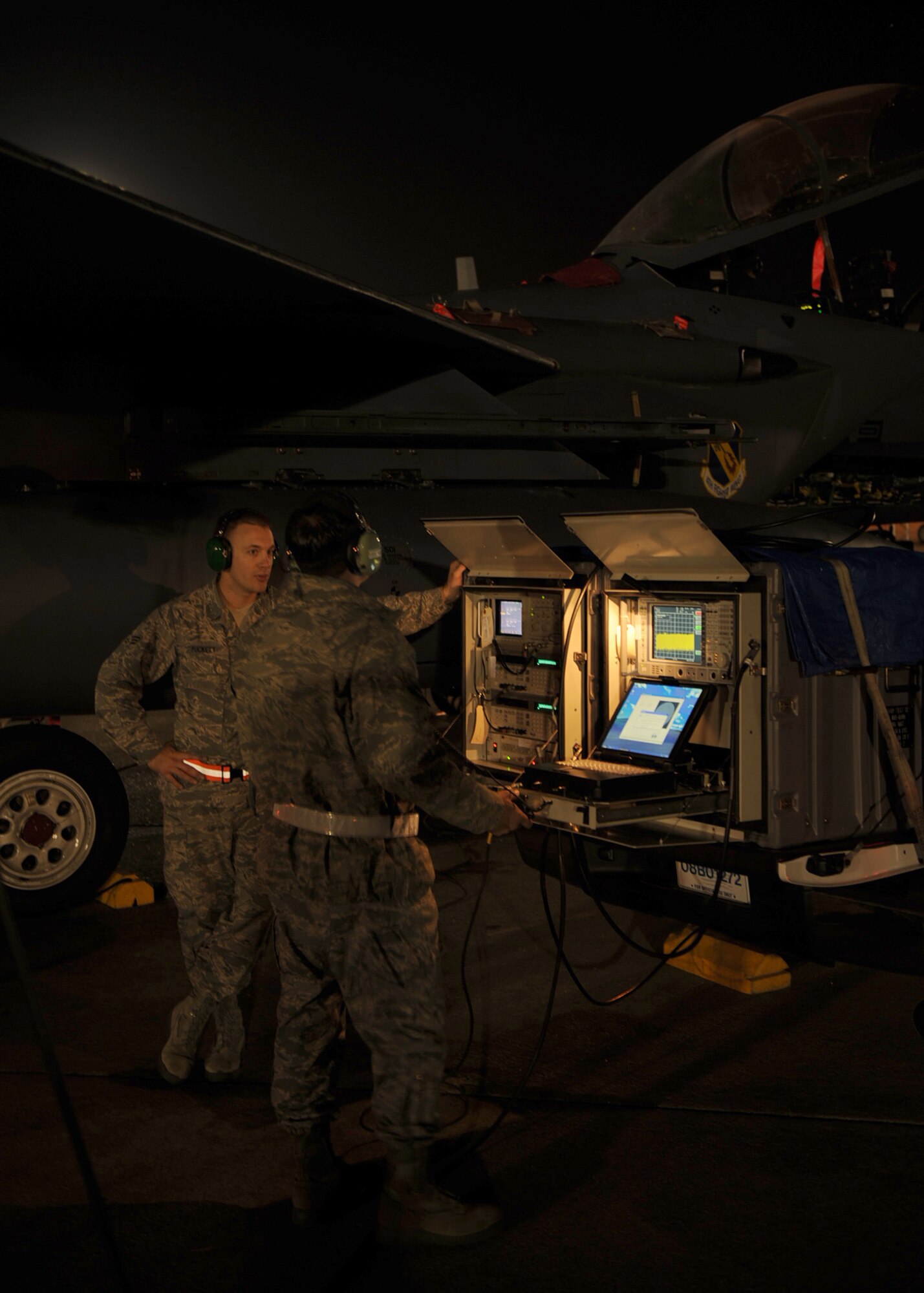 Senior Airman Timothy Puckett (left) and Tech. Sgt. Edward Youmans (right), Combat Shield team members from Eglin Air Force Base, Fla., monitor signals sent to the cockpit of an F-15E Strike Eagle on Seymour Johnson Air Force Base, N.C., Oct. 20, 2009. Combat Shield is a program that assesses the fighter fleet, electronic warfare systems and combat readiness. (U.S. Air Force photo/Senior Airman Ciara Wymbs) 
