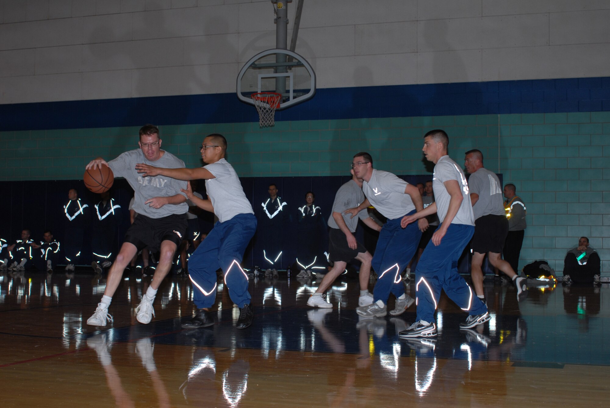 GOODFELLOW AIR FORCE BASE, Texas -- Soldiers from the 344th Military Intelligence Battalion team up against Airmen from the 17th Logistics Readiness Squadron during a 3-on-3 basketball game at a wing sports day event, Oct. 23, 2009. Sports day provided a variety of activities for all personnel including volleyball, badminton, dodge ball and more. (U.S. Air Force photo/Staff Sgt. Laura R. McFarlane)