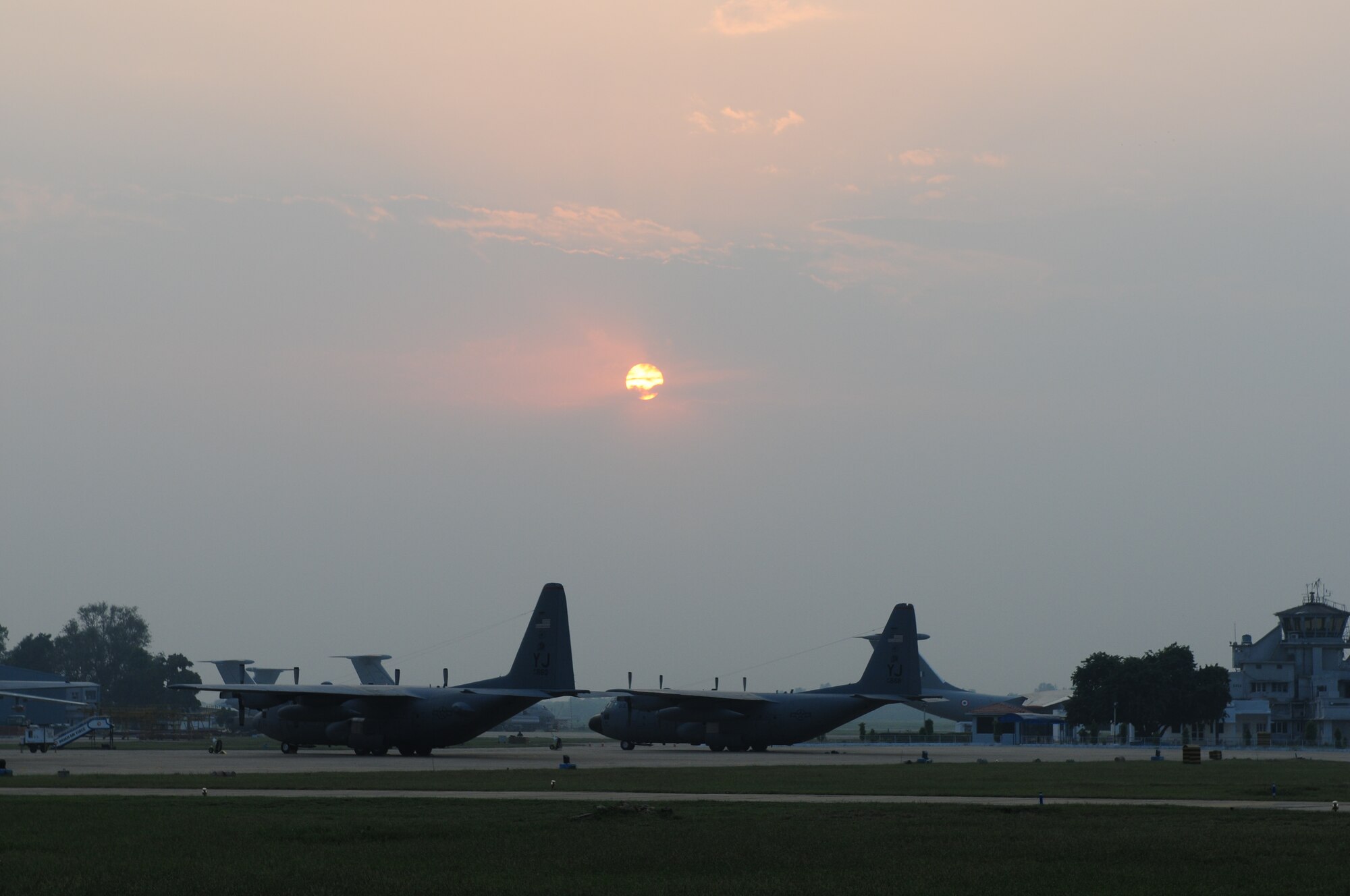 Two C-130 Hercules rest after a long day of missions during exercise Cope India at Air Force Station Agra, India. Cope India is a United States and India airlift exercise that provides training for humanitarian assistance and disaster relief operations. (U.S. Air Force photo/Capt. Genieve David)