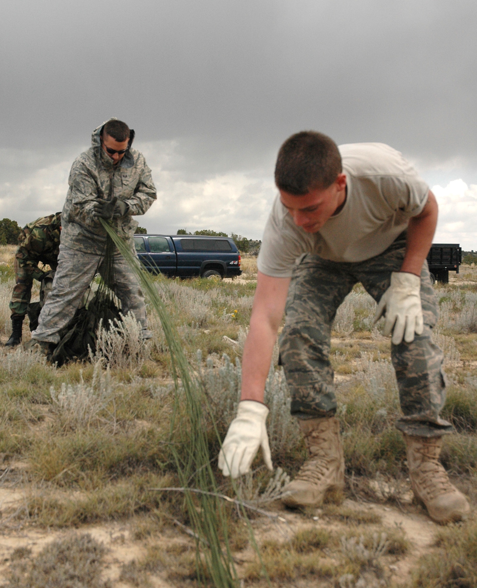 Senior Airman Kacy Foshee (foreground), 39th Aerial Port Squadron air transportation apprentice, works with members of his squadron to collect parachute cord after a simulated container delivery system drop Sept. 24 at Fort Carson, Colo. The drop, conducted by a C-130 Hercules crew assigned to the Air Force Reserve's 302nd Airlift Wing, supported the U.S. Air Force Academy's Airdrop Enhanced Logistics Visibility System prototype system that demonstrated the ability of commanders in the field and at the headquarters level to simultaneously identify the location and contents of a CDS within minutes of the cargo leaving the aircraft. The AELVIS project aims to provide war fighters in locations like Iraq and Afghanistan with exact details on crucial cargo drops for resupply. (U.S. Air Force photo/Capt. Jody L. Ritchie)