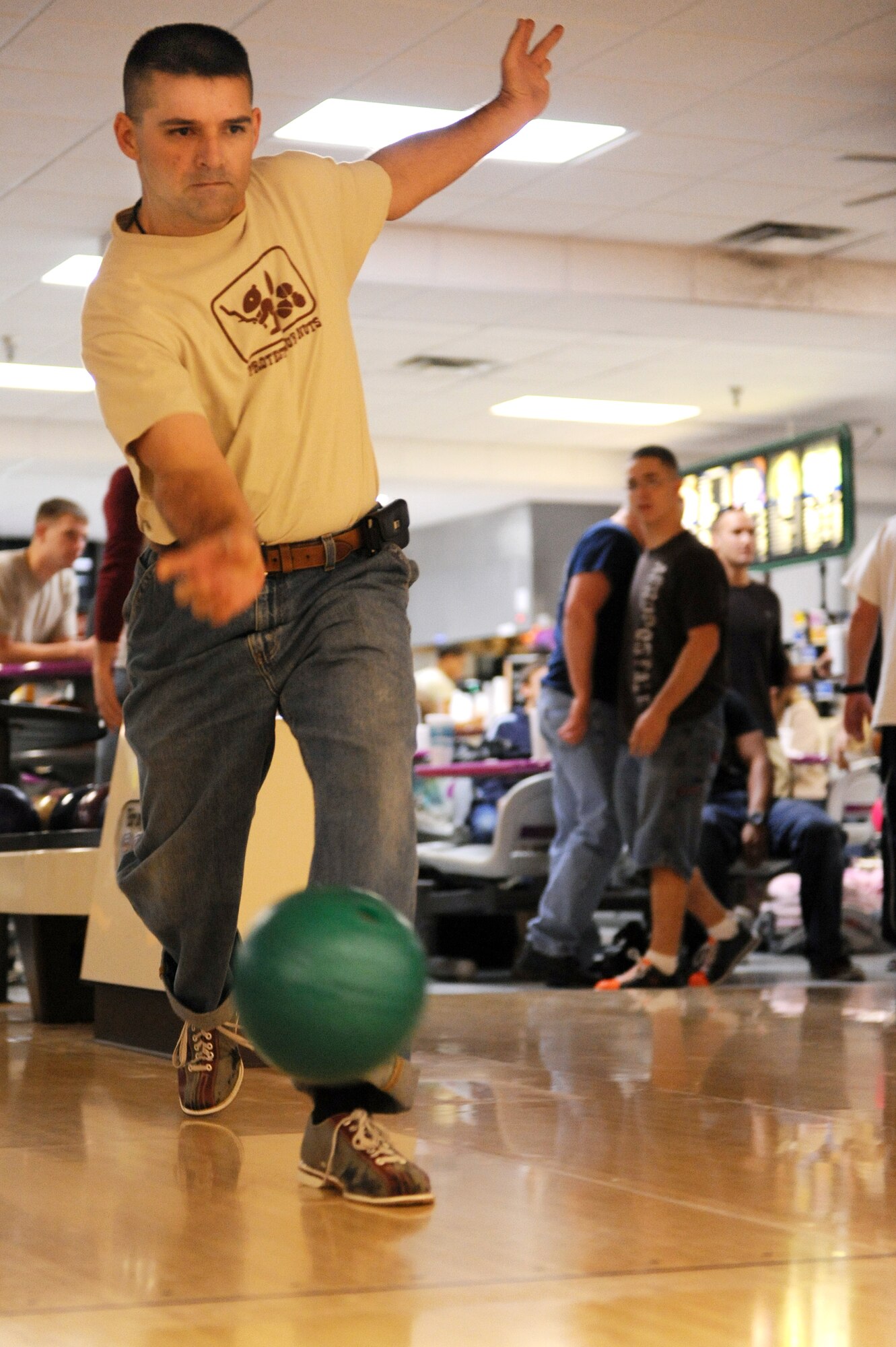 A member of Team Little Rock slings his bowling ball down the lane in hopes of a strike during the base's Combined Federal Campaign bowling tournament fundraiser at the base bowling alley Oct. 23. The CFC fundraising campaign is from Oct. 13 through Nov. 20. (U.S. Air Force Photo by Senior Airman Jim Araos)