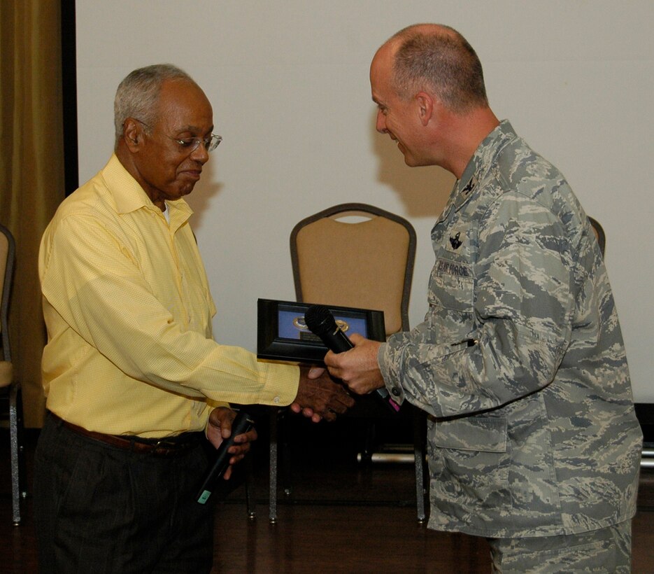 Major Gen. (ret) Joseph McNeil receives a token of appreciation from Col. Jon Andre, vice commander, 22nd Air Force, for his dedication to the Air Force Reserve Human Resource Development Council at McGuire AFB for a conference Nov. 21. General McNeil was one of the first servicemembers appointed to initiate a HRDC in the Air Force Reserve and over saw many of the developments that set the foundation for the program’s success. He gave a speech to servicemembers from every wing under the 22nd Air Force (U.S. Air Force photo/Senior Airman Shaun Shenk)