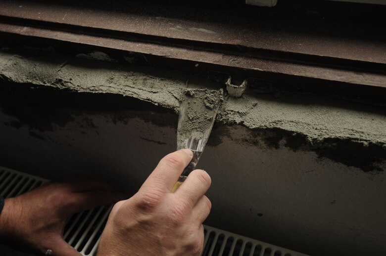 CAMPIA TURZII, Romania – Staff Sgt. Dennis Sawyer, 52nd Equipment Maintenance Squadron, prepares the wall of a children’s community center in Turda, Romania, for repainting while deployed in support of Operation Dacian Thunder Oct. 26. Members of Spangdahlem Air Base donated money and time to help refurbish the center during their deployment. The center provides academic help to about 50 local children after school to ensure they graduate. (U.S. Air Force photo/Senior Airman Benjamin Wilson)