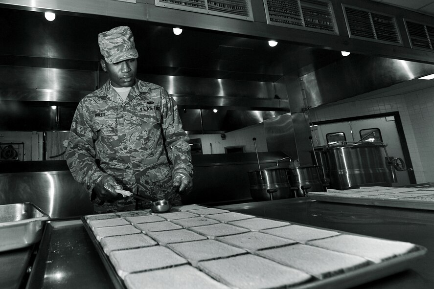 OFFUTT AIR FORCE BASE, Neb., -- Airman Basic Richie Willis, 55th Force Support Squadron, places butter on toasted bread as he prepares lunch at the Ronald L. King Dining Facility here Oct. 22. The King Dining Facility serves more than 17,000 meals a month providing food for Offutt's warriors. Air Combat Command's Hennessy Inspection Team visits Offutt Nov. 1 - 4 to evaluate the King Dining Facility and the Campsisi Dining Facility as they compete for the prestigious Hennessy Award, an honor that recognizes the best Dining Facility Program in the Air Force. U.S. Air Force Photo by Charles Haymond