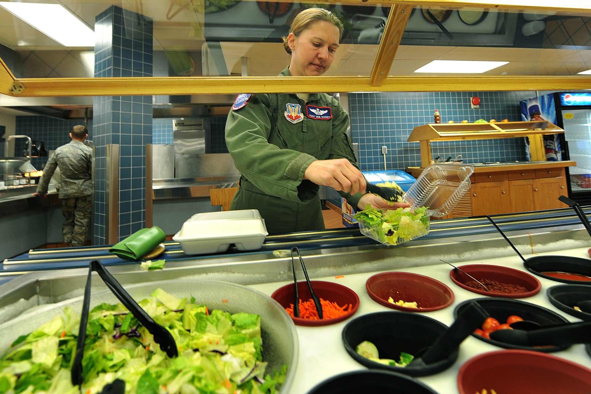 OFFUTT AIR FORCE BASE, Neb., -- Tech. Sgt. Deborah Rainey, 55th Operations Group, makes a salad during lunch service at the Ronald L. King Dining Facility here Oct. 22. The King Dining Facility serves more than 17,000 meals a month providing food for Offutt's warriors. Air Combat Command's Hennessy Inspection Team visits Offutt Nov. 1 - 4 to evaluate the King Dining Facility and the Campsisi Dining Facility as they compete for the prestigious Hennessy Award, an honor that recognizes the best Dining Facility Program in the Air Force. U.S. Air Force Photo by Charles Haymond 