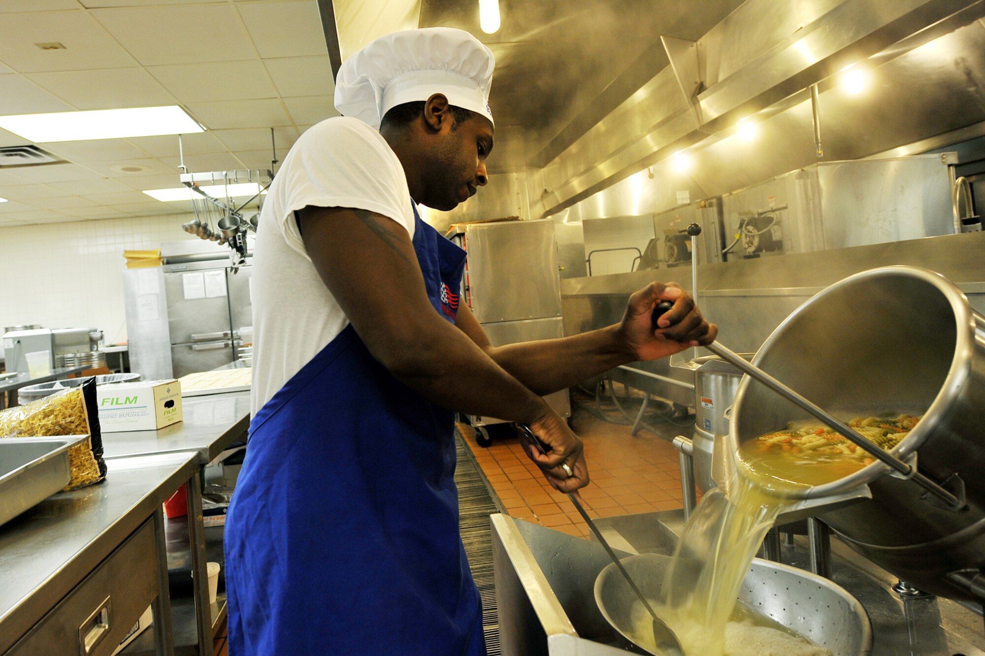 OFFUTT AIR FORCE BASE, Neb., -- Staff Sgt. Nolan Coppedge, 55th Force Support Squadron, drains water from a pot of streamed vegetables as he helps prepare lunch at the Ronald L. King Dining Facility here Oct. 22. The King Dining Facility serves more than 17,000 meals a month providing food for Offutt's warriors. Air Combat Command's Hennessy Inspection Team visits Offutt Nov. 1 - 4 to evaluate the King Dining Facility and the Campsisi Dining Facility as they compete for the prestigious Hennessy Award, an honor that recognizes the best Dining Facility Program in the Air Force. U.S. Air Force Photo by Charles Haymond