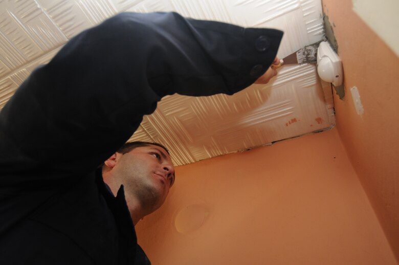 CAMPIA TURZII, Romania – Staff Sgt. Dennis Sawyer, 52nd Equipment Maintenance Squadron, prepares the wall of a children’s community center in Turda, Romania, for repainting while deployed in support of Operation Dacian Thunder 2009 Oct. 26. Members of Spangdahlem Air Base donated money and time to help refurbish the center during their deployment. The center provides academic help to about 50 local children after school to ensure they graduate. (U.S. Air Force photo/Senior Airman Benjamin Wilson)