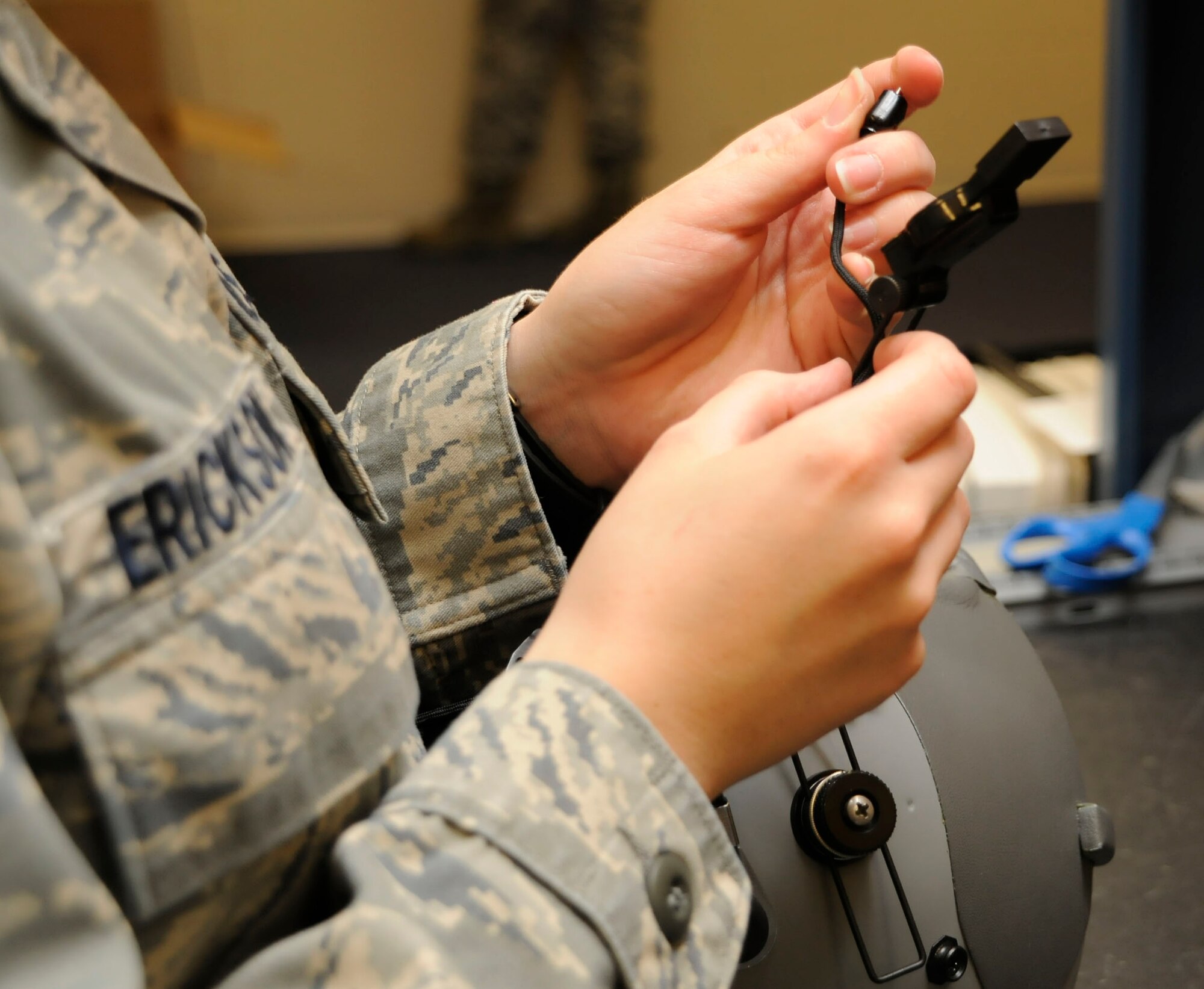 CANNON AIR FORCE BASE, N.M. -- Airman 1st Class Katie Erickson, 27th Special Operations Support Squadron, installs a boom microphone on a HGU-55/P flyers helmet here, Oct. 26. The microphone allows pilots to communicate when the mask is not compeletely on. (U.S. Air Force photo/ Senior Airman Erik Cardenas)