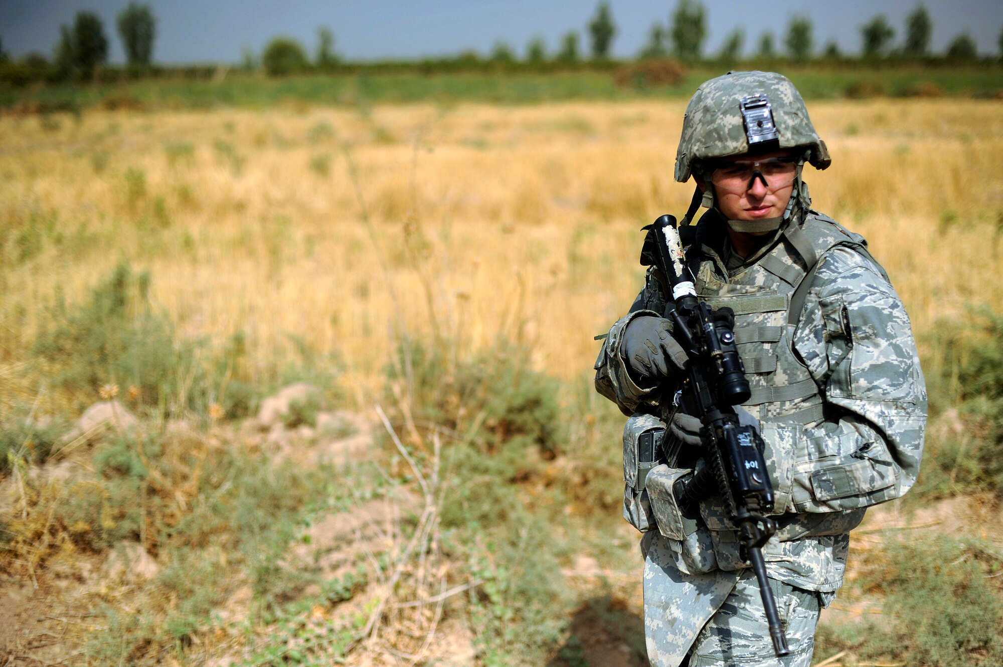 Senior Airman Michael Emerson scans a field during a force protection patrol Oct. 17, 2009, outside Joint Base Balad, Iraq. Members of the 532nd Expeditionary Security Forces Squadron patrol to provide a security presence intended to deter anyone who would do harm to the people who live and work at the base. Airman Emerson is assigned to the 532nd ESFS. (U.S. Air Force photo/Staff Sgt. Michael B. Keller) 
