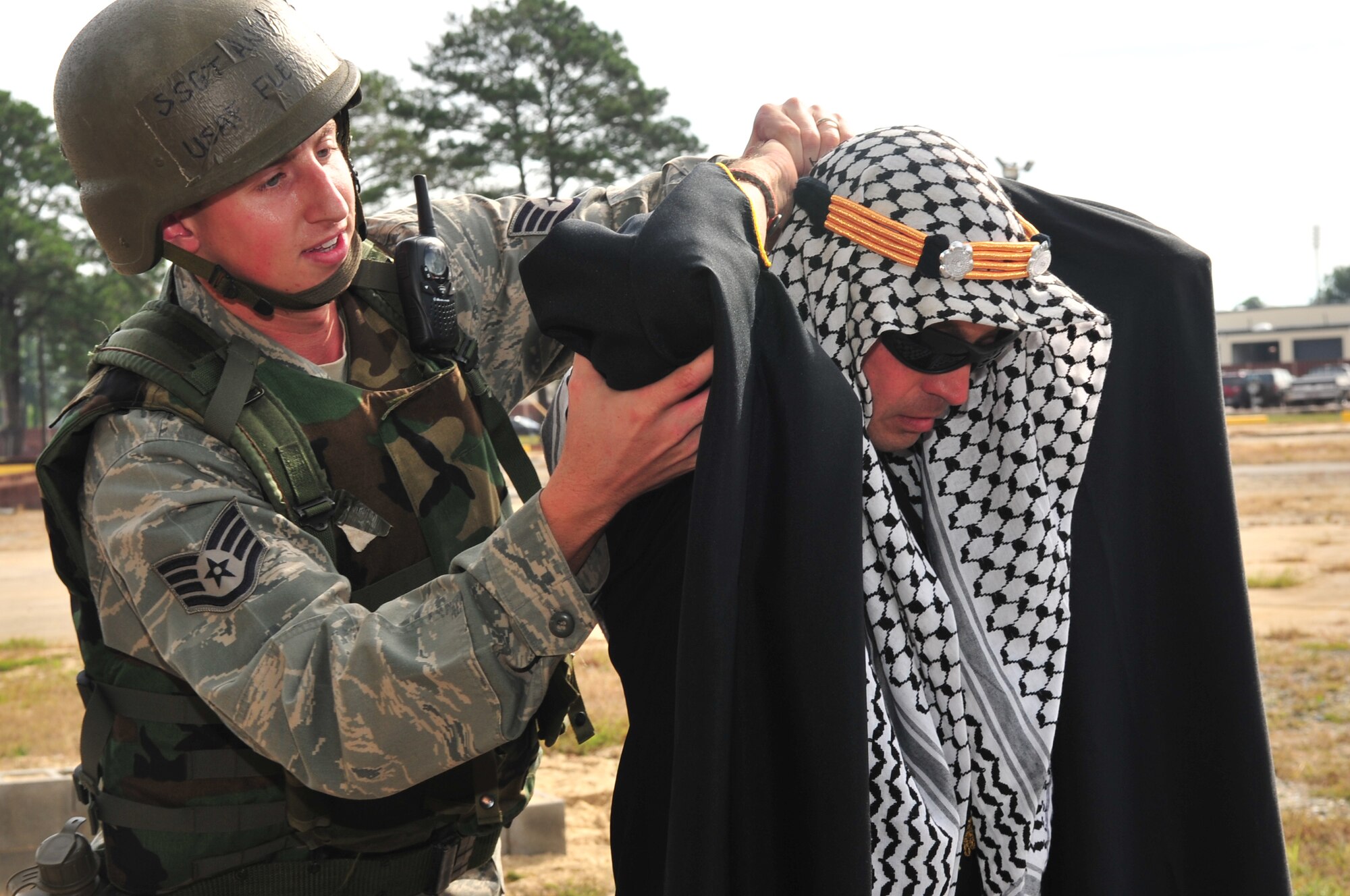 Staff Sgt. Anthony Fletcher, 4th Civil Engineer Squadron utilities systems journeyman, searches a simulated Afghani tribal chief for weapons during expeditionary combat skills training at Seymour Johnson Air Force Base, N.C., Oct. 22, 2009. Airmen are trained on proper searching techniques and what to do if a weapon is found. (U.S. Air Force photo/Airman 1st Class Rae Perry)