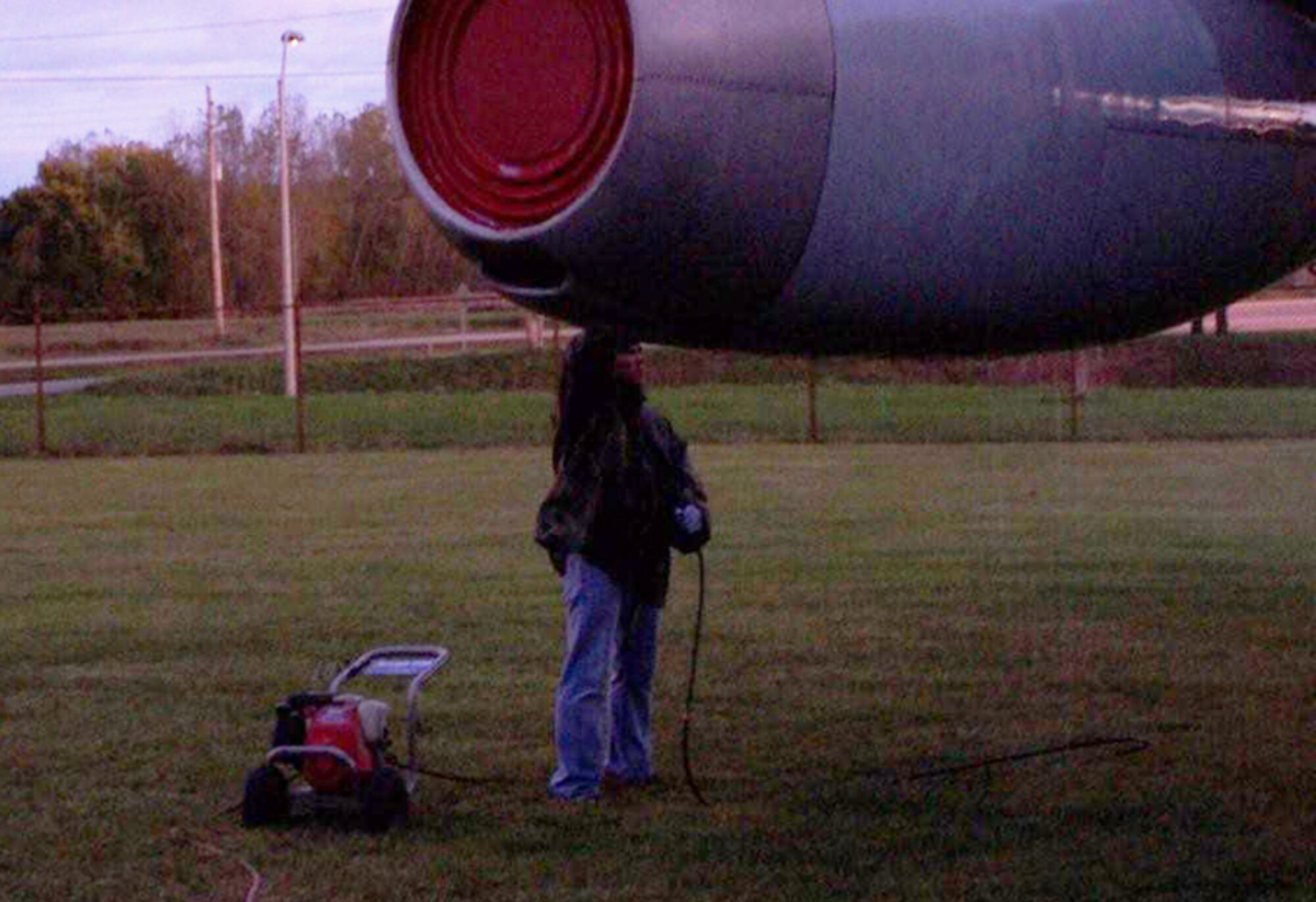 GRISSOM AIR RESERVE BASE, Ind., -- Senior Airman Mark Peavler, an aircraft mechanic with the 434th Aircraft maintenance Squadron, hurries to wash an engine on the EC-135 before the sun sets and darkness descends. He was one of three volunteers who donated their off-duty time to help the Grissom Air Museum. (Courtesy photo)