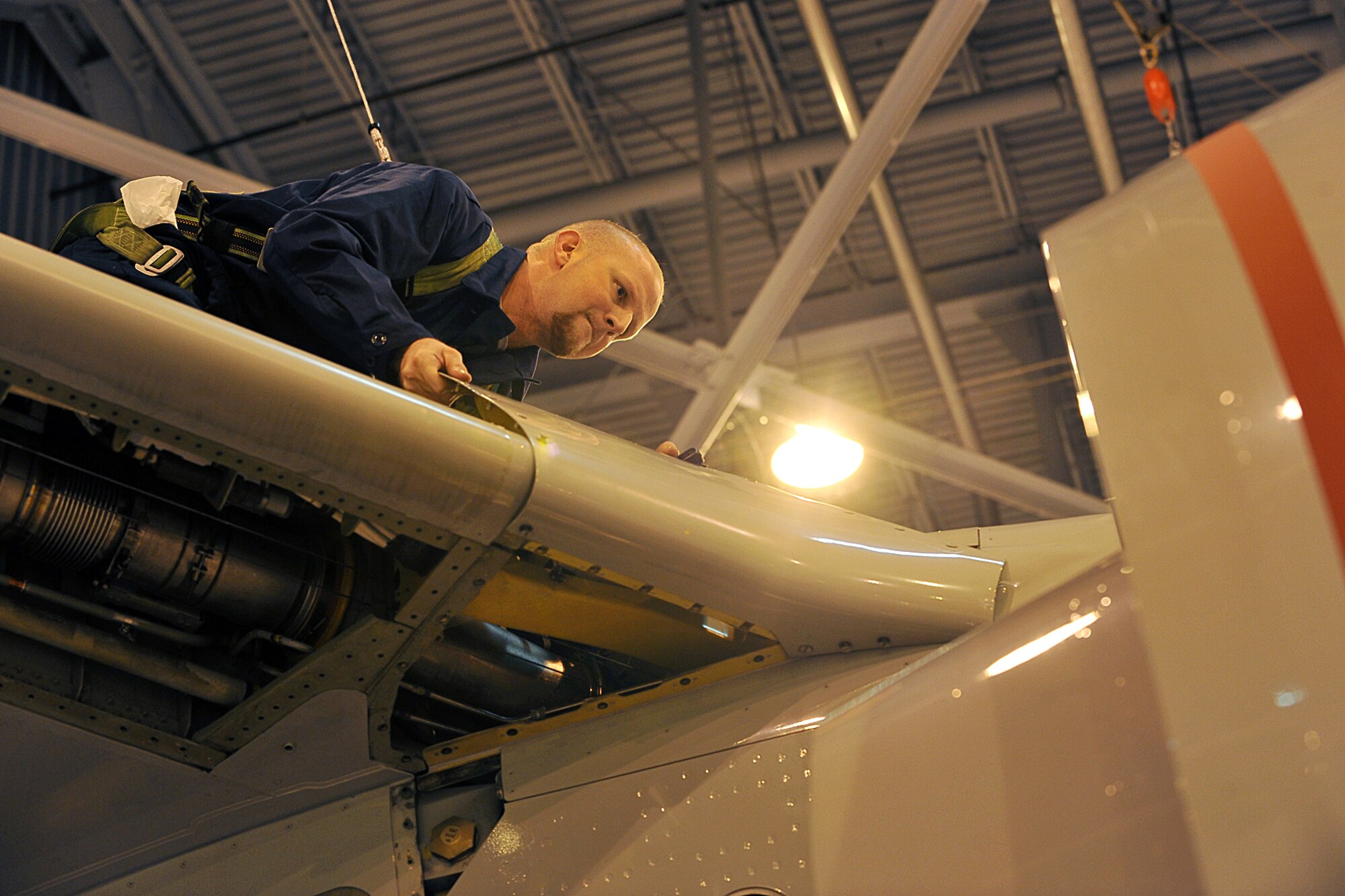 OFFUTT AIR FORCE BASE, Neb., -- Shane Conaway, a jet engine mechanic with the 55th Maintenance Squadron isochronal phased inspection dock, removes a panel from the right wing of an RC-135 aircraft during an isochronal inspection at the Bennie Davis Maintenance Facility here Oct. 23. In the isochronal phase inspection dock, approximately 40 people are responsible for maintaining Offutt's 135's and ensuring they are mission ready. The performance of the 55th MXS isochronal inspection dock during a recent inspection helped the 55th Wing earn the Meritorius Unit Award. U.S. Air Force Photo by Charles Haymond

