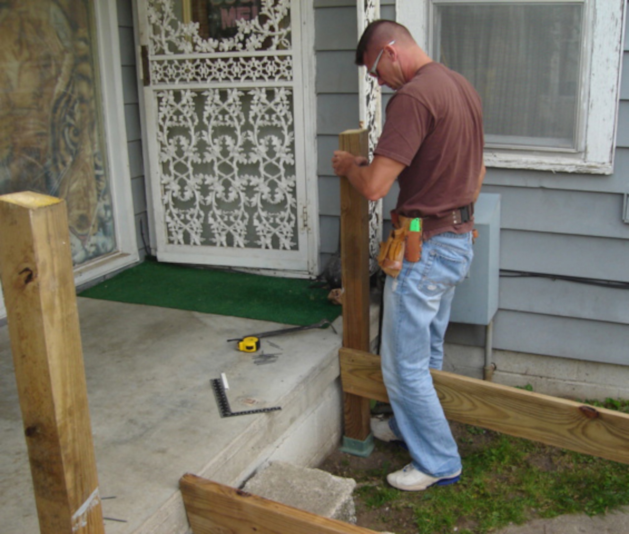 KOKOMO,  Ind., -- Master Sgt. Paul Tomlinson works to shore up the foundation of a ramp being built for a local disabled veteran. Sergeant Tomlinson, along with other members of the 434th Air Refueling Wing, donated their off-duty time to construct the ramp.                          