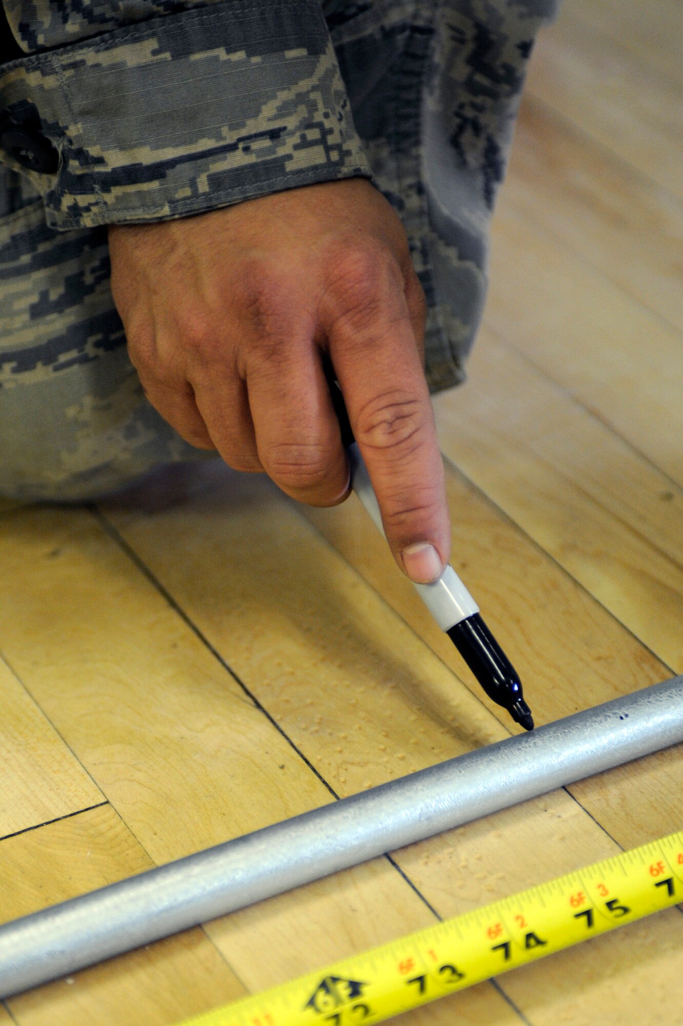 Staff Sgt. James Livingston, 28th Civil Engineer Squadron electrical systems technician, marks a spot on a pipe to determine where it needs to be bent here, Oct. 22. Sergeant Livingston is preparing to make a conduit to run power to a back room at the youth center. (U.S. Air Force photo/Airman 1st Class Matthew Flynn)