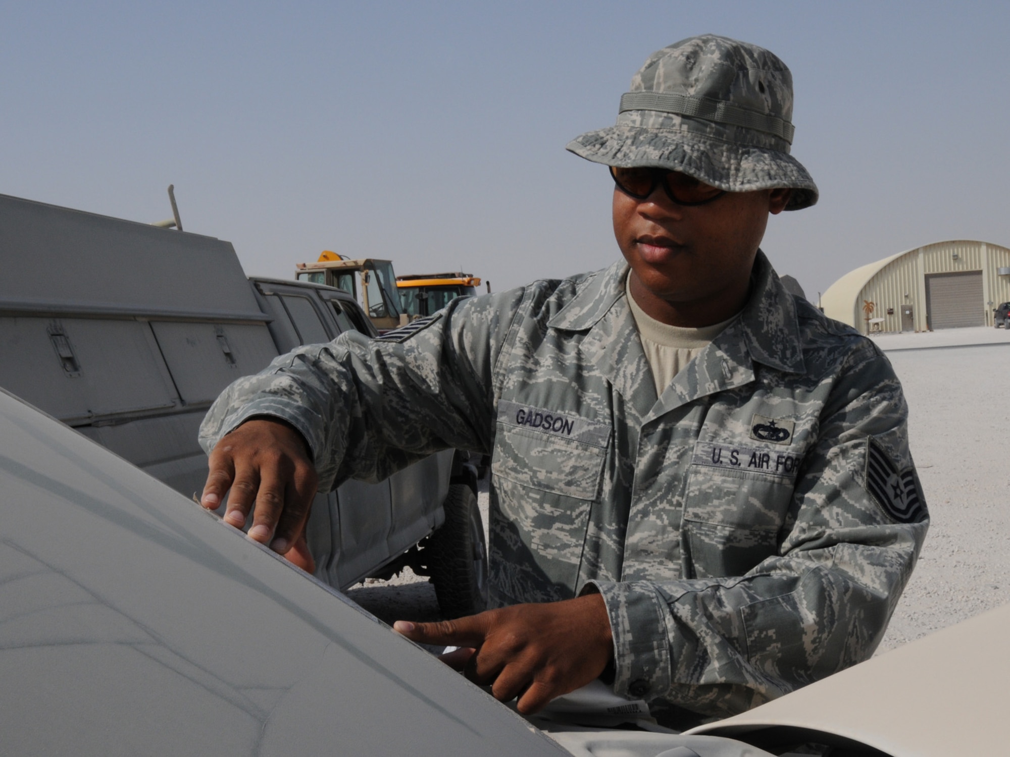 Tech. Sgt. Joseph Gadson, 379th Expeditionary Logistics Readiness Squadron NCOIC container manager, attaches a shipping label to a turned-in vehicle prior to shipment for final disposition. The Transit Shipping Point is responsible for cataloging and organizing equipment for shipping to Defense Reutilization and Marketing Offices. Sergeant Gadson is deployed from Keesler Air Force Base, Miss. in support of operations Iraqi Freedom and Enduring Freedom. (U.S. Air Force Photo/Tech. Sgt. Jason W. Edwards)