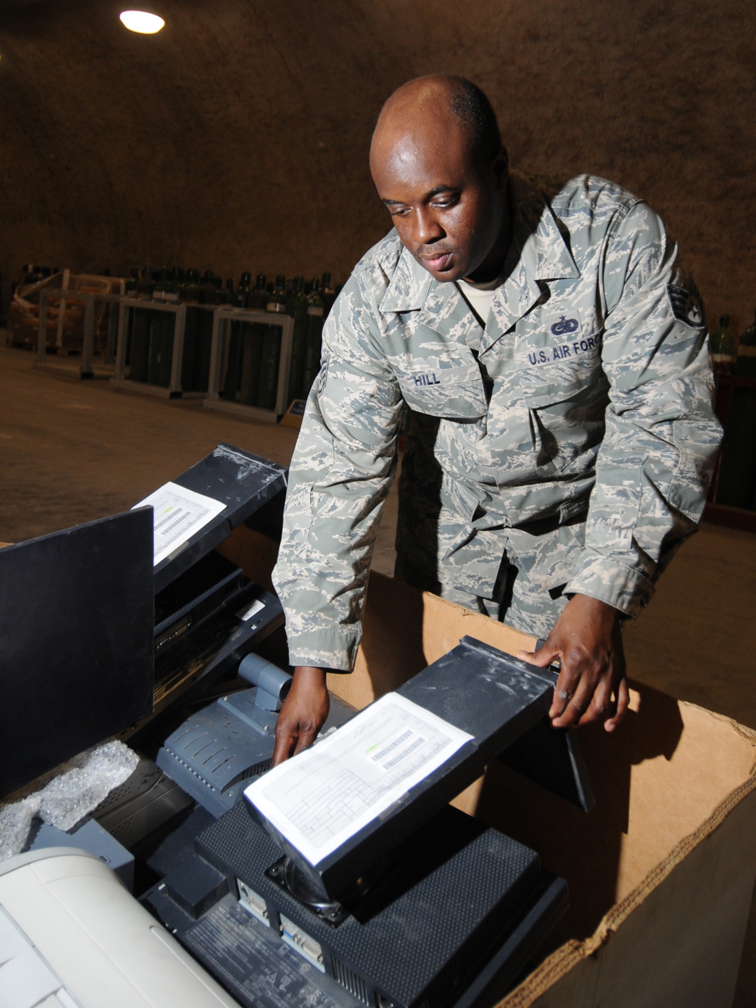Staff Sgt. Travis Hill, 379th Expeditionary Logistics Readiness Squadron transit shipping point NCOIC, prepares unserviceable equipment for shipping. The Transit Shipping Point is responsible for cataloging and organizing equipment for shipping to Defense Reutilization and Marketing Offices. Sergeant Hill is deployed from Grand Forks Air Force Base, N.D. in support of operations Iraqi Freedom and Enduring Freedom. (U.S. Air Force Photo/Tech. Sgt. Jason W. Edwards)