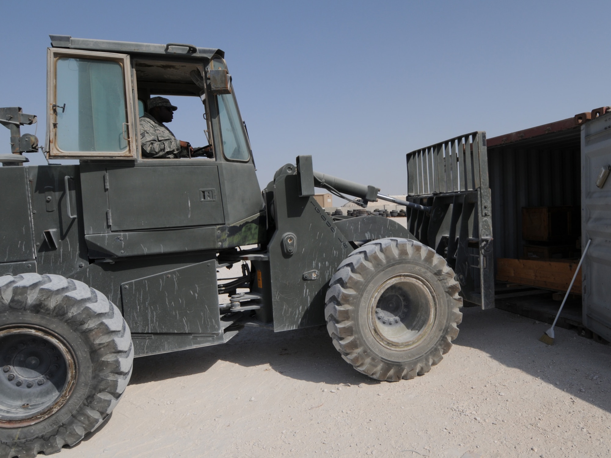 Staff Sgt. Travis Hill, 379th Expeditionary Logistics Readiness Squadron transit shipping point NCOIC, loads unserviceable equipment into containers for shipping. The Transit Shipping Point is responsible for cataloging and organizing equipment for shipping to Defense Reutilization and Marketing Offices. Sergeant Hill is deployed from Grand Forks Air Force Base, N.D. in support of operations Iraqi Freedom and Enduring Freedom. (U.S. Air Force Photo/Tech. Sgt. Jason W. Edwards)