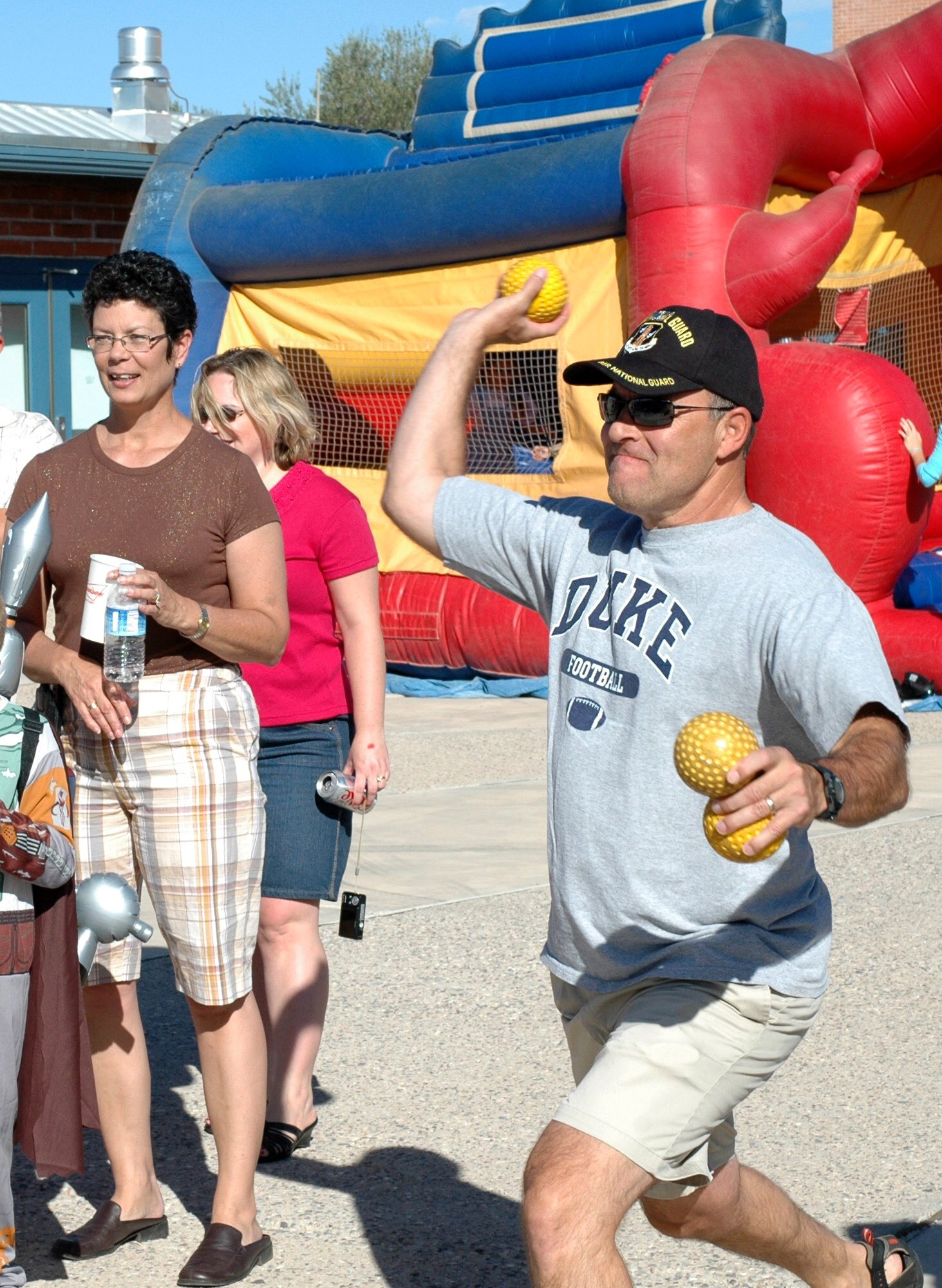 Col. Greg Stroud, 162nd Fighter Wing commander, throws a fast ball in an attempt to drop Col. Ted Maxwell, vice commander, into the dunk tank. Several wing leaders volunteered for the tank at the Haunted Hangar to raise funds for the Family Readiness Group. (Air National Guard photo by Maj. Gabe Johnson)