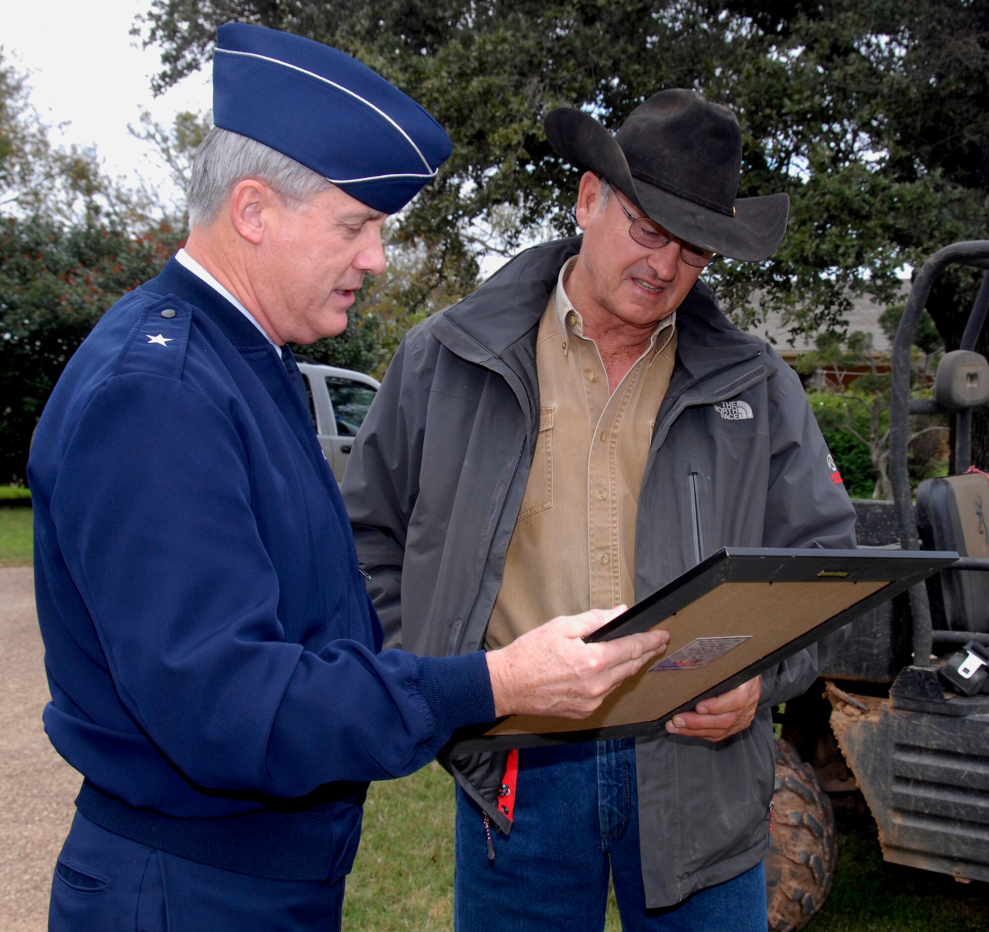Brig. Gen. O.G. Mannon (left), 82nd Training Wing commander, presents a "thank you" gift to Emry Birdwell Oct. 26 as a token of appreciation. The Birdwell-Clark Ranch near Henrietta, Texas, hosted more than 170 Airmen from Sheppard Sept. 5 for the ranches 5th Annual Dove Hunt. (U.S. Air Force photo/Mike Litteken)