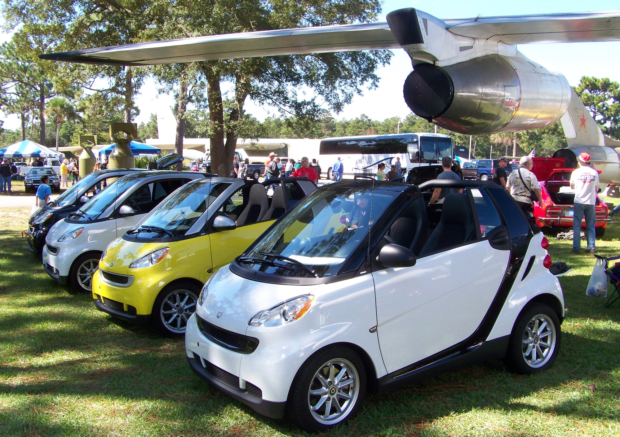 A collection of European Smart cars sit on display under the wing of an F-101 at the 2009 Commando Cruise-In at the Air Force Armament Museum Oct. 24. The cars were entered in different categories including size and country of origin. (U.S. Air Force photo by Airman 1st Class Joe McFadden.)