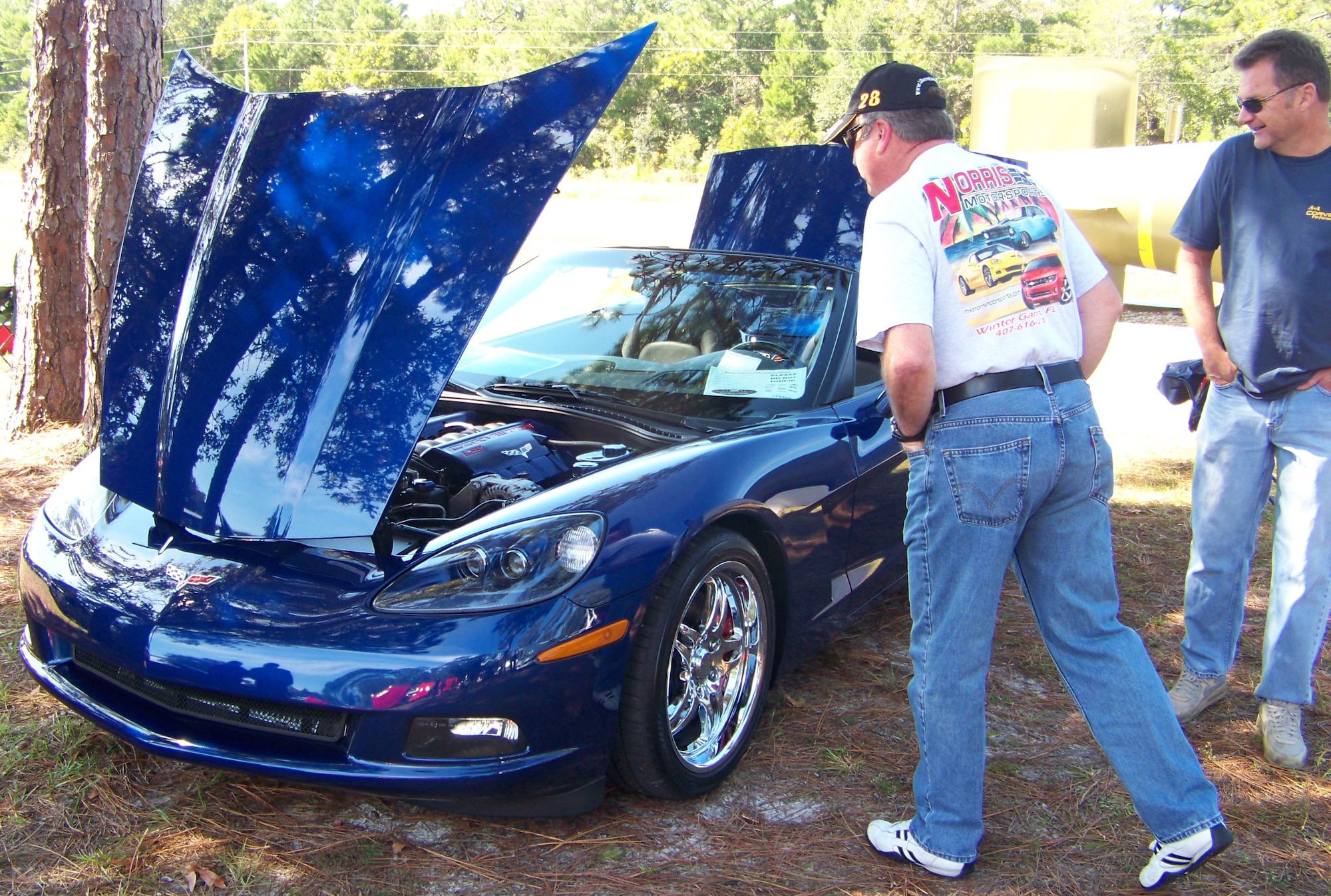 Two men check out a Chevrolet Corvette at the 2009 Commando Cruise-In at the Air Force Armament Museum Oct. 24. The Corvette was one of many muscle cars on display at the car show. (U.S. Air Force photo by Airman 1st Class Joe McFadden.)