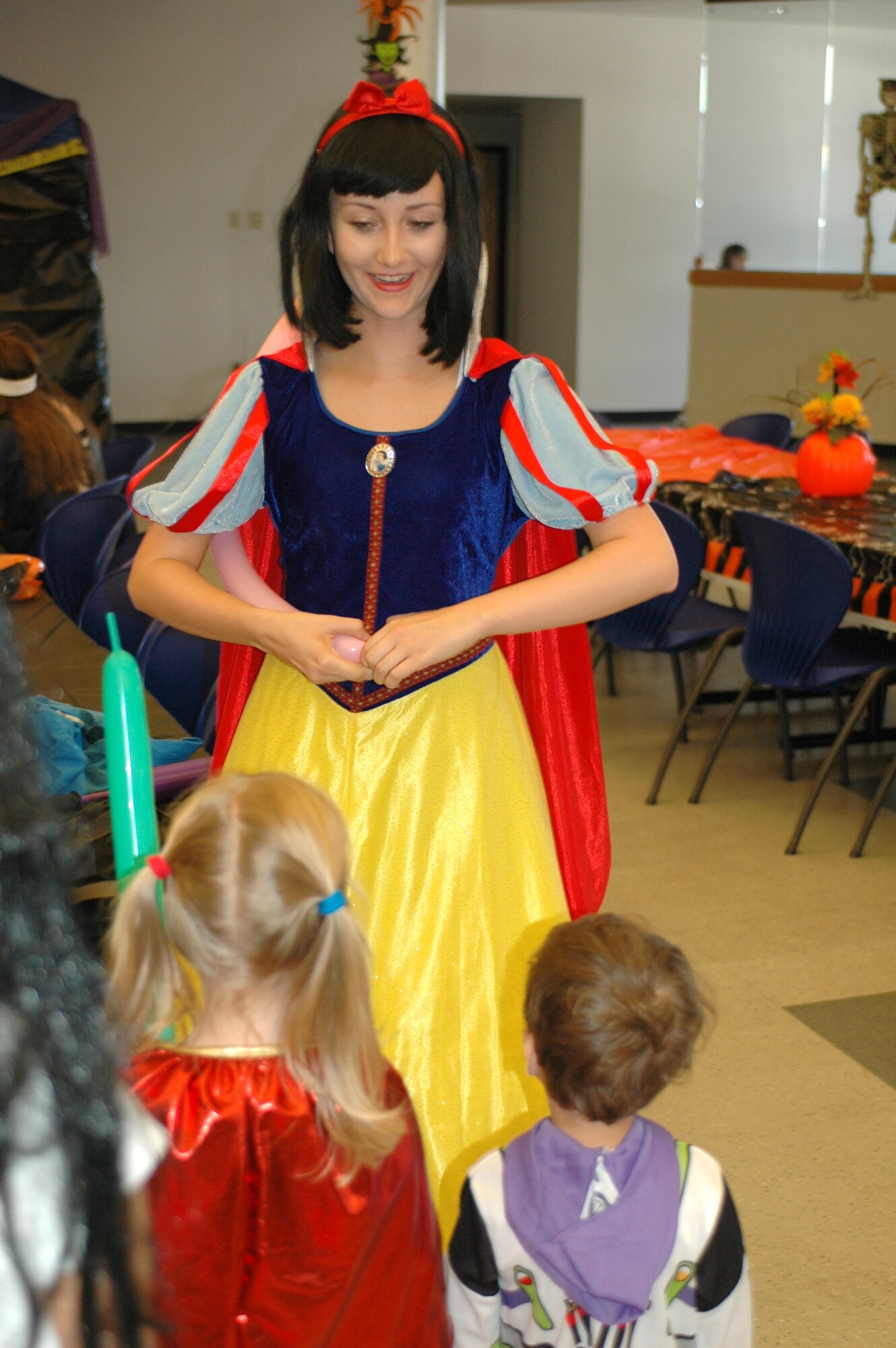 A balloon artist dressed as Snow White makes balloon animals for children at the 2009 Haunted Hangar. (Air National Guard photo by Maj. Gabe Johnson)