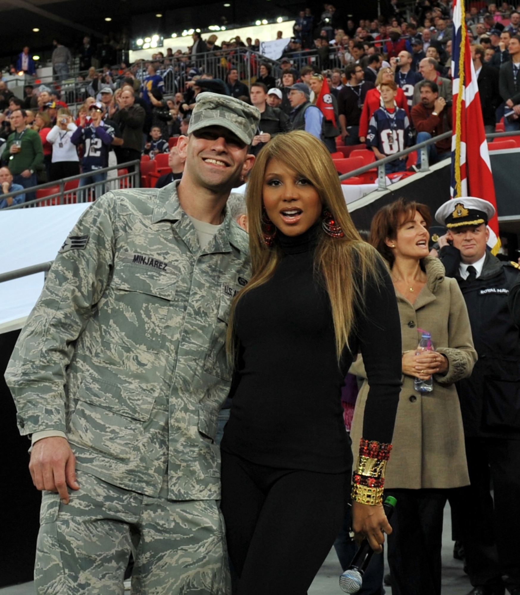 United States Air Force Senior Airman Manuel Minjarez with pop sensation Toni Braxton prior to the NFL game at Wembley Stadium.   (Photo by Air Force Staff Sgt. Javier Cruz)
