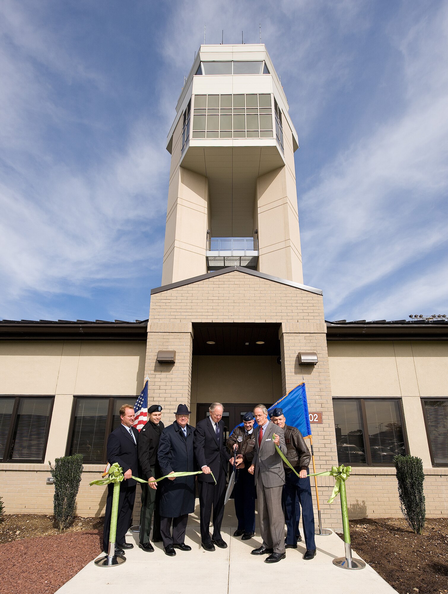 (From left) Matt Conologue, Tetra Tech Facilities on-site senior project manager, Lt. Col. Thomas Tickner, U.S. Army Corps of Engineers Philadelphia District commander, Carleton Carey, City of Dover mayor, Rep. Mike Castle, Col. Manson Morris, 436th Airlift Wing commander, Sen. Tom Carper, and Col. Dave Horton, 436th Operations Group commander, cut the ribbon to open the new Air Traffic Control Facility at Dover Air Force Base Oct. 26. The new facility will combine the control tower with the radar approach control facility to streamline operations and enhance efficiency. (U.S. Air Force photo by Jason Minto)