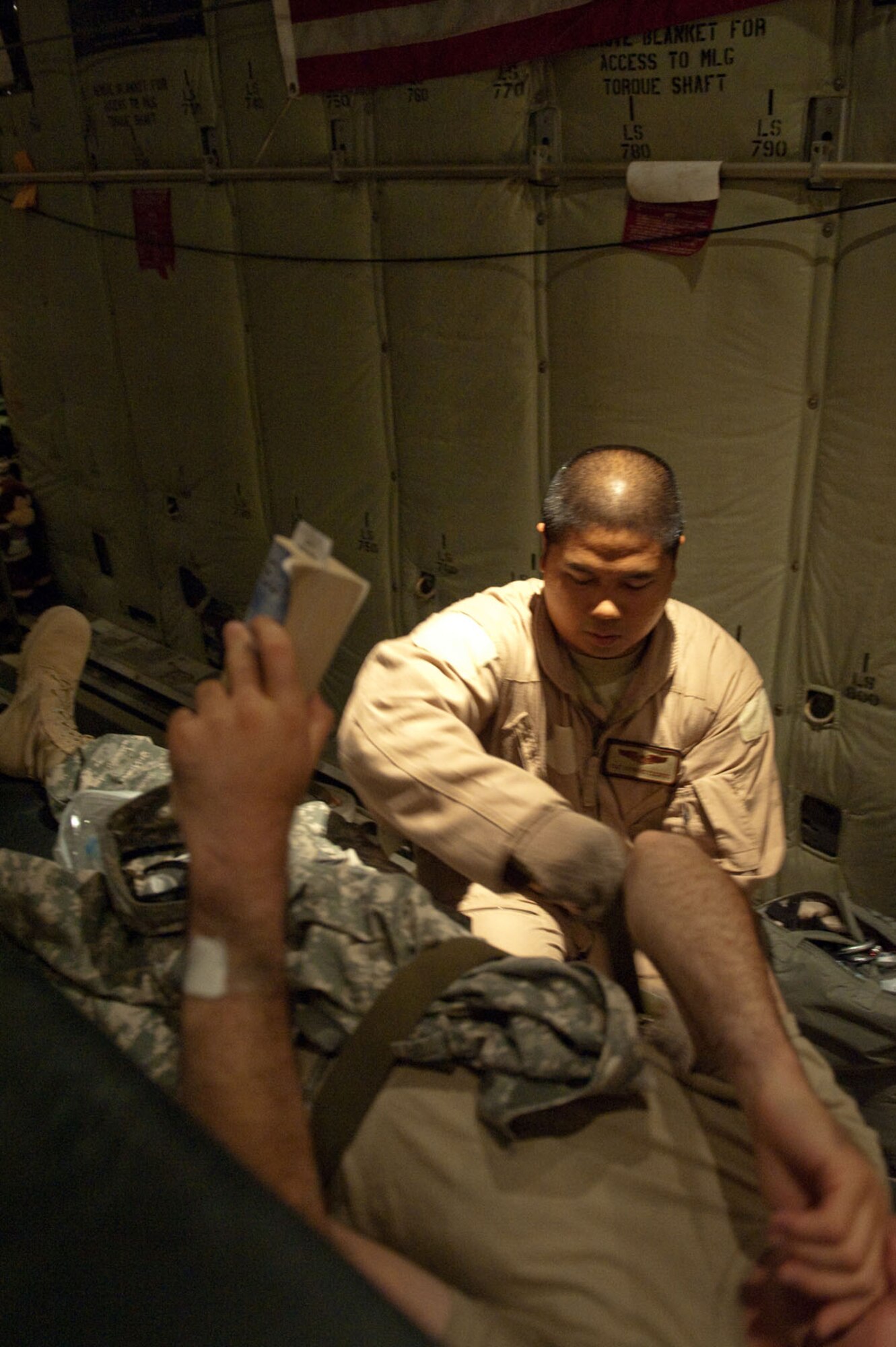 Tech. Sgt. Raymond Escorido, 379th Expeditionary Aeromedical Evacuation Squadron aeromedical technician, helps secure a medical patient on board a C-130J Hercules in preparation for a regularly scheduled aeromedical evacuation mission, Oct. 24, 2009, in Southwest Asia. The 379 EAES provides a routine "mercy mission" that transports patients from throughout Southwest Asia to established medical care facilities in support of operations Iraqi Freedom and Enduring Freedom. (U.S. Air Force photo/Staff Sgt. Robert Barney)