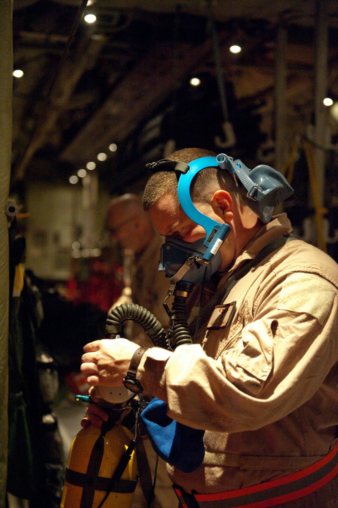 Senior Master Sgt. Patrick Skiver, 379th Expeditionary Aeromedical Evacuation Squadron aeromedical technician, performs a function check on his aircrew breathing mask as he prepares for a mission, Oct. 24, 2009, in Southwest Asia. The 379 EAES provides a regular "mercy mission" that transports patients from throughout Southwest Asia to established medical care facilities in support of operations Iraqi Freedom and Enduring Freedom. (U.S. Air Force photo/Staff Sgt. Robert Barney) 