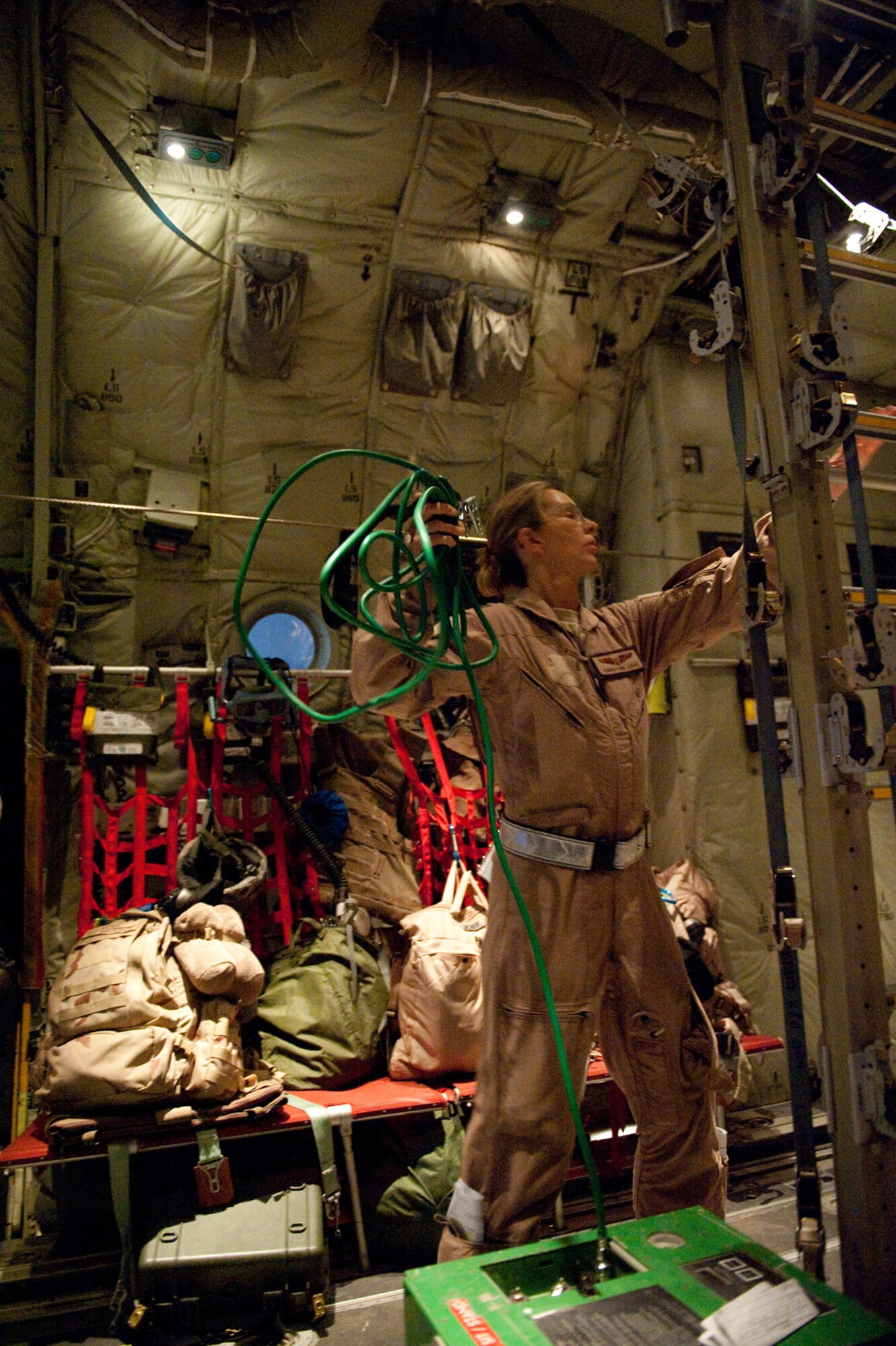 Capt. Christine Love, 379th Expeditionary Aeromedical Evacuation Squadron flight nurse, prepares medical equipment on a C-130J Hercules in preparation for patients, Oct. 24, 2009, in Southwest Asia. The 379 EAES provides a regular "mercy mission" that transports patients from throughout Southwest Asia to established medical care facilities in support of operations Iraqi Freedom and Enduring Freedom. (U.S. Air Force photo/Staff Sgt. Robert Barney) 