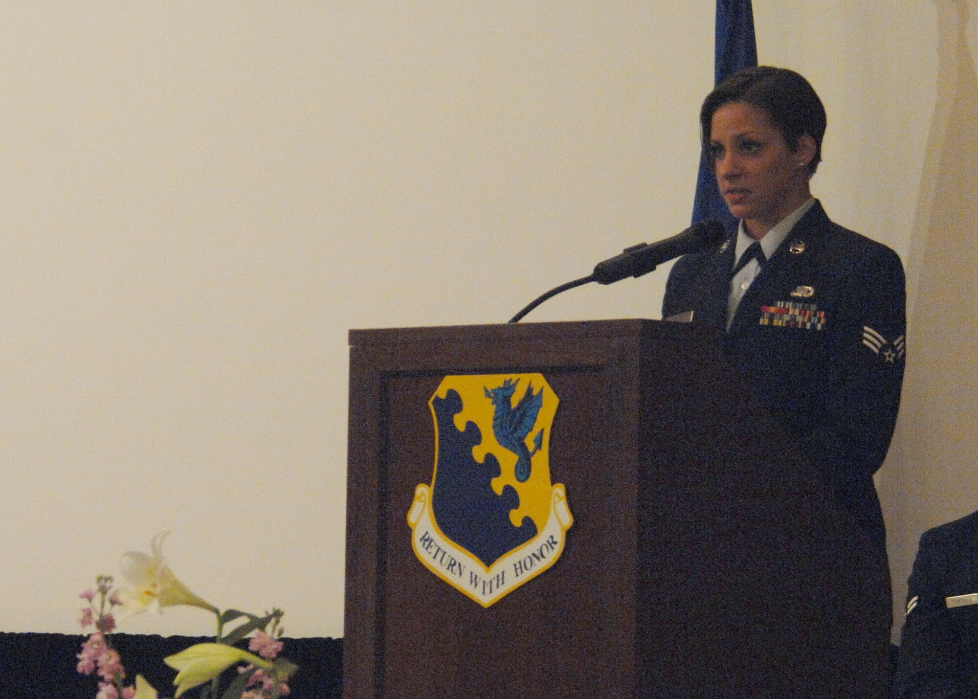 Senior Airman Jaime Ciciora, a close friend from the American Forces Network Aviano affiliate talks about the kind of person Airman 1st Class Lauren Lagudi was during a memorial service held in her honor Oct. 26, 2009 at the Aviano Air Base, Italy base theater.  (U.S. Air Force photo Senior Airman Tabitha Mans)