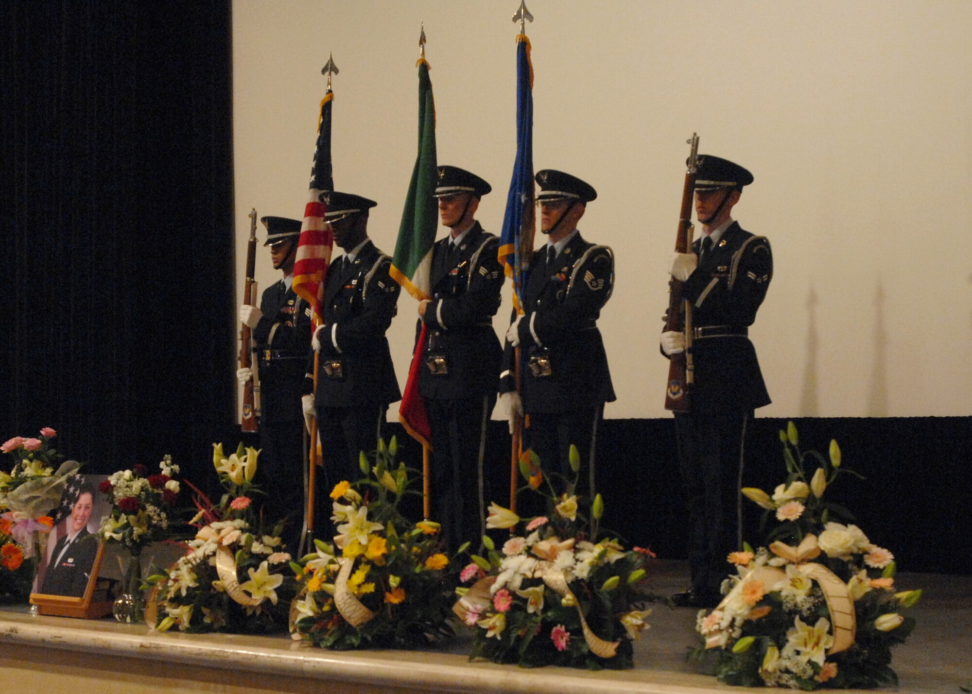 Members of the 31st Fighter Wing base honor guard post the colors during the memorial service held here Oct. 26, 2009 at the base theater in honor of Airman 1st Class Lauren Lagudi.  Airman Lagudi was a broadcaster assigned to the American Forces Network Aviano affiliate.  (U.S. Air Force photo Senior Airman Tabitha Mans)