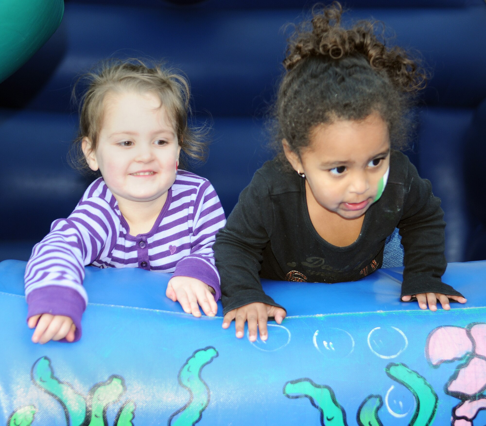 RAF MILDENHALL, England -- Natalie Mathis (left) and Elsie Zachry, both 2,  play in a bouncy castle at the Child Development Center here Oct. 23. The girls played carnival-style games and ate barbecue at the 2009 Fall Festival hosted by the Parent Advisory Committee. The committee holds several events throughout the year for children of the CDC and meets once a month to discuss ways to improve the center. Their meetings are at 4:30 p.m. on the third Wednesday of every month in the CDC's resource room. (U.S. Air Force photo/Senior Airman Thomas Trower)