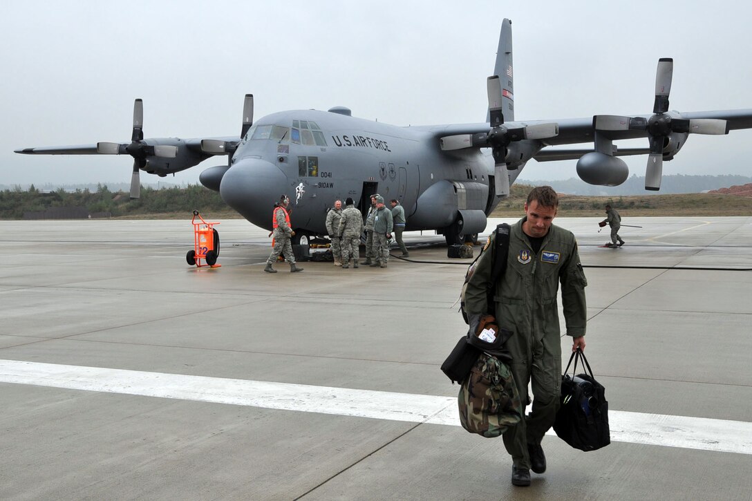 RAMSTEIN AIR BASE, Germany -- Air Force Reserve Capt. Chris May walks away from a C-130H Hercules tactical cargo transport aircraft, assigned to the 910th Airlift Wing based at Youngstown Air Reserve Station, Ohio, on the flightline here, October 23, 2009. Captain May and eight other Citizen Airmen from YARS have just completed an airlift mission delivering passengers and cargo to the country of Moldova, located in eastern Europe between Romania and the Ukraine. As Captain May walks from the aircraft, crew chiefs and aircraft maintenance personnel are preparing to conduct a basic post-flight inspection on the aircraft. The aircrew members completing this airlift mission are among more than 70 Servicemembers from the 910th AW attached to the 38th Expeditionary Airlift Squadron, based here. The 38th EAS is supporting Operation Joint Enterprise by providing tactical airlift capability to locations in the U.S. Europe Command (EUROCOM), U.S. Africa Command (AFRICOM) and U.S. Central Command (CENTCOM) theaters of operations. U.S. Air Force photo by Master Sgt. Bob Barko Jr.  
